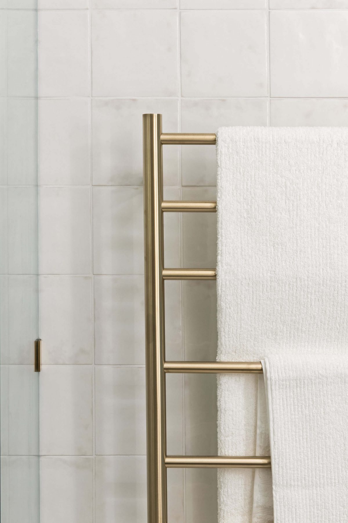 A custom designed bathroom featuring gold accents. Designed and built by MJ Harris Group.