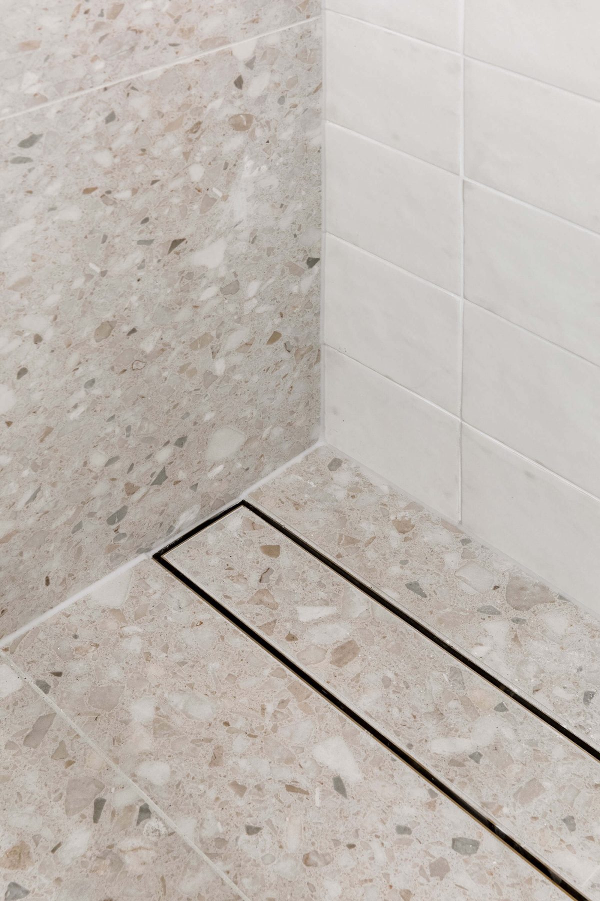 A custom designed bathroom featuring gold accents. Designed and built by MJ Harris Group.