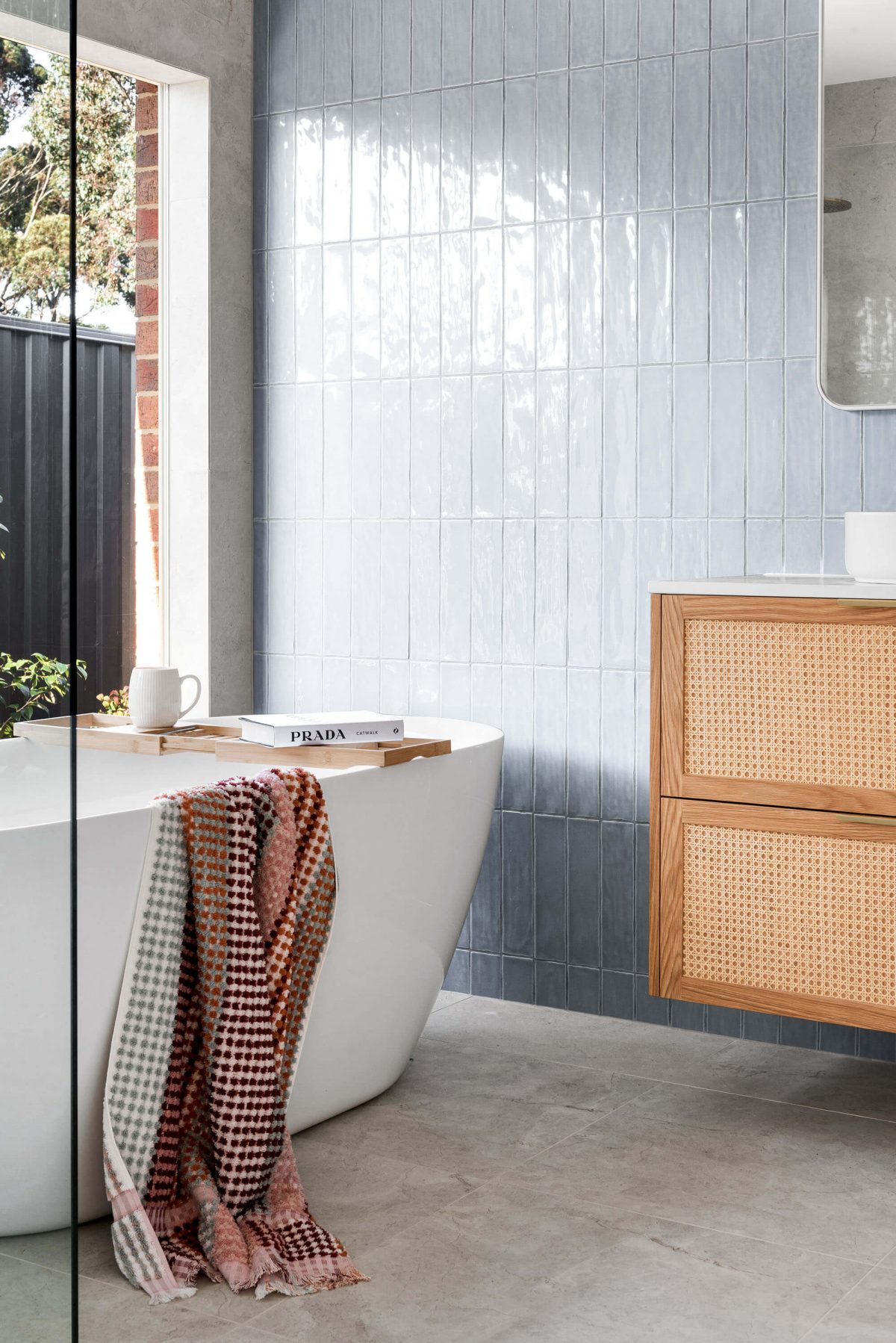 A custom designed bathroom featuring blue tiles. Designed and built by MJ Harris Group.