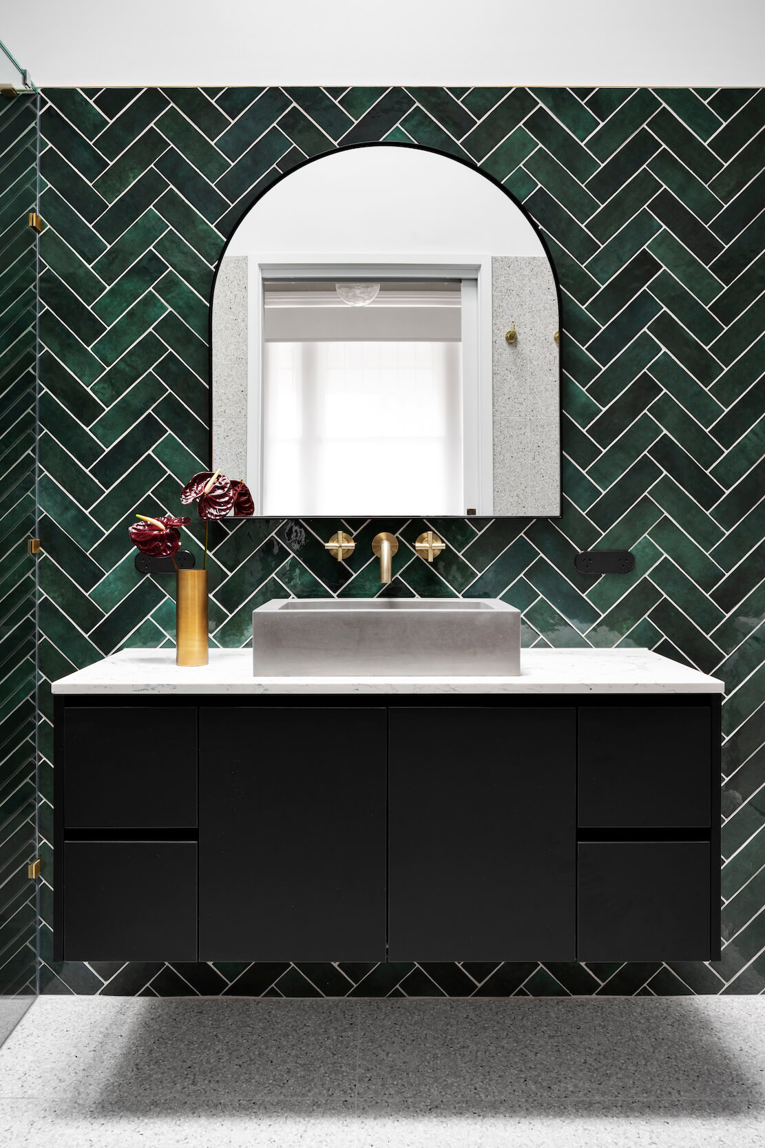 A custom designed bathroom featuring green tiles. Designed and built by MJ Harris Group.