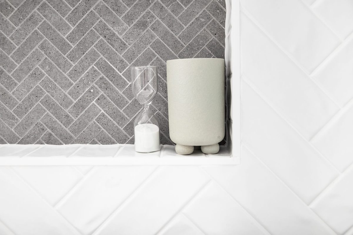 A custom designed bathroom featuring white tiles. Designed and built by MJ Harris Group. #MJHxSpringfeildSt