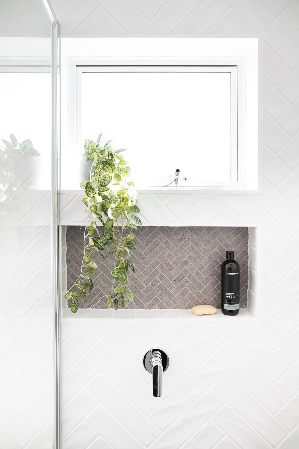 A custom designed bathroom featuring white tiles. Designed and built by MJ Harris Group. #MJHxSpringfeildSt