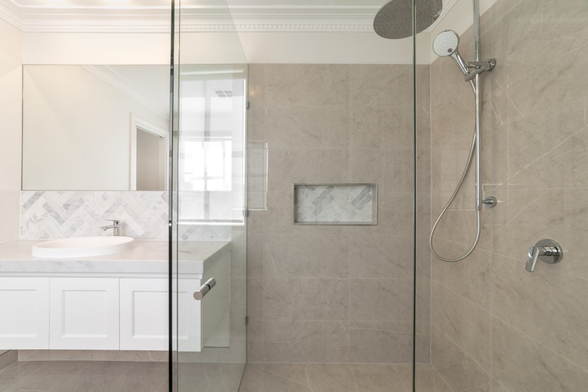A custom designed bathroom featuring chrome fixtures. Designed and built by MJ Harris Group.