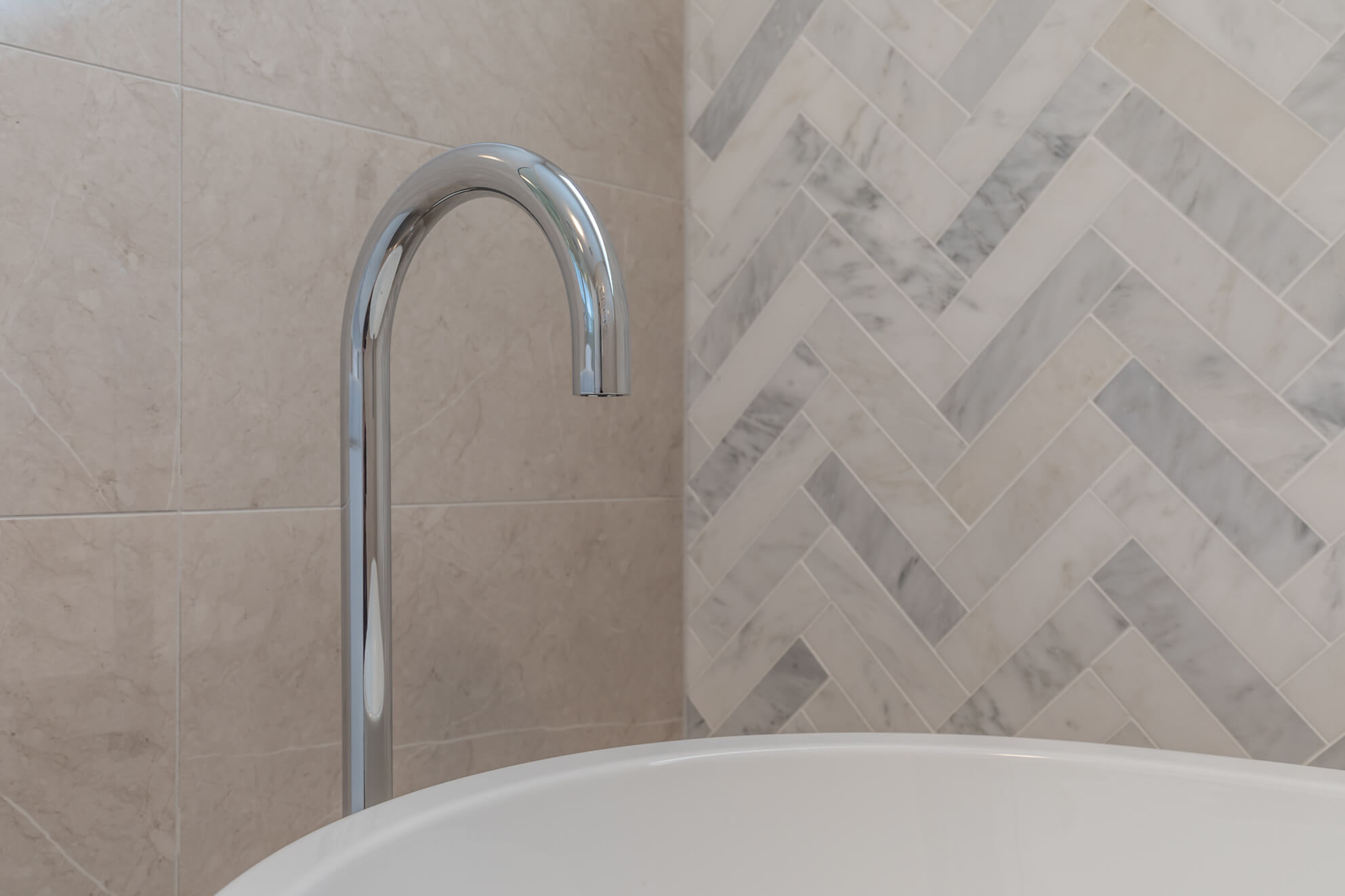 A custom designed bathroom featuring chrome fixtures. Designed and built by MJ Harris Group.