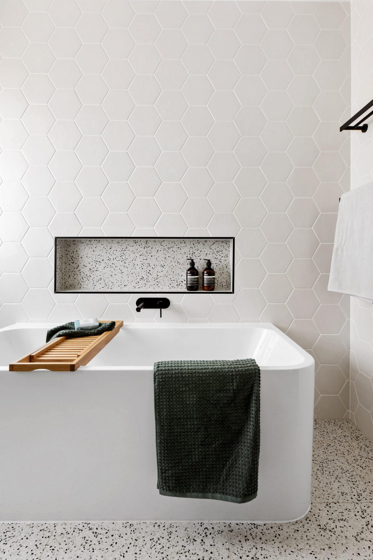 A custom designed bathroom featuring black accents. Designed and built by MJ Harris Group.