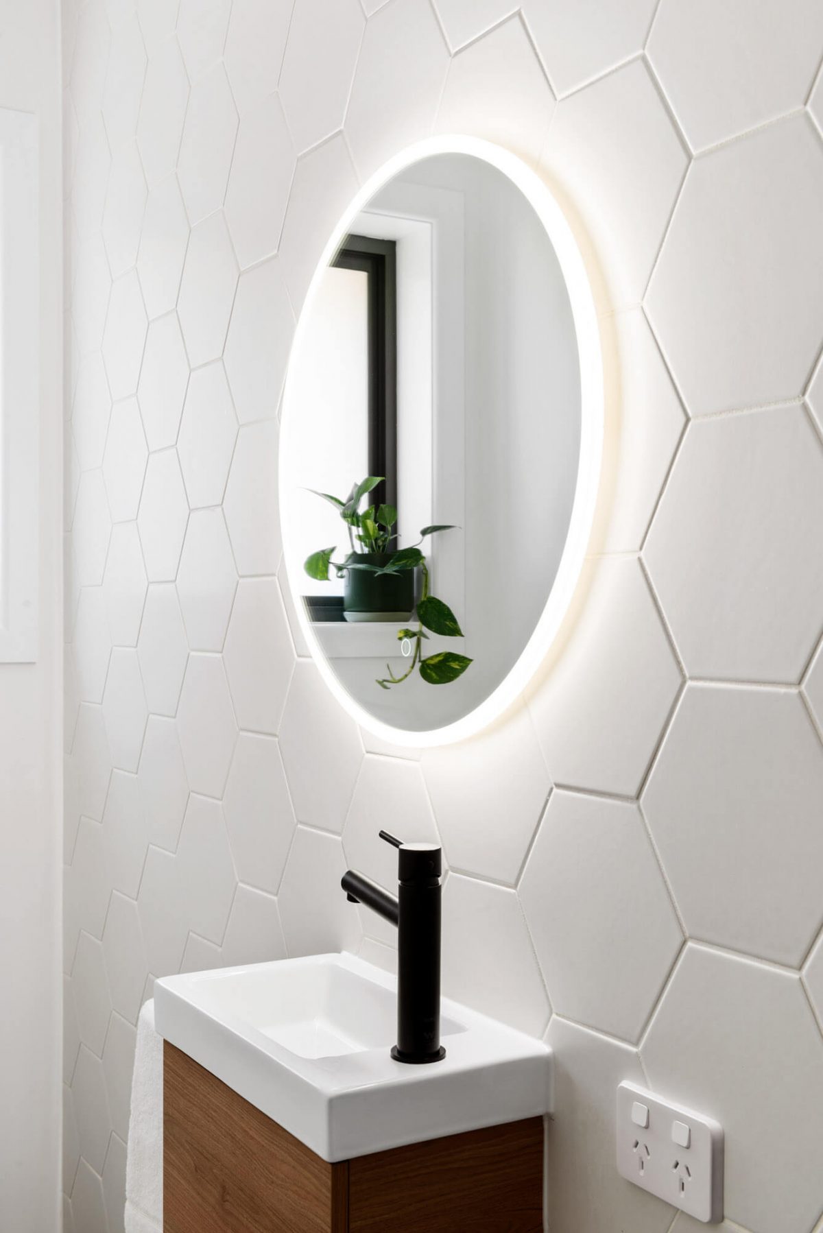 A custom designed bathroom featuring black accents. Designed and built by MJ Harris Group.