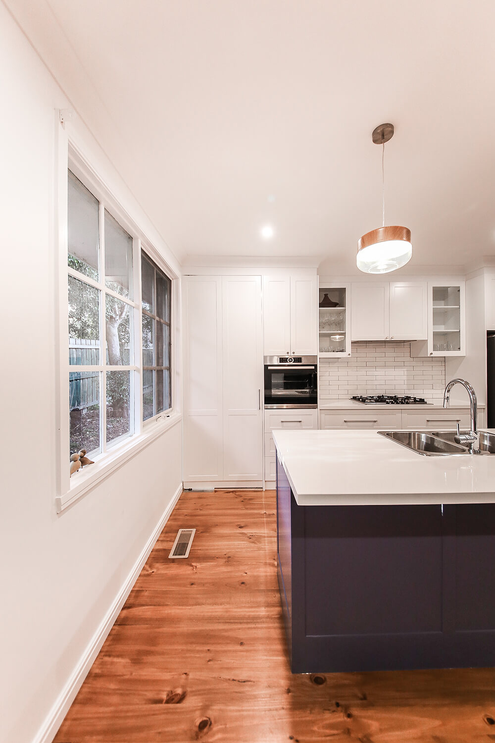 A custom designed kitchen featuring subway tiles. Designed and built by MJ Harris Group.