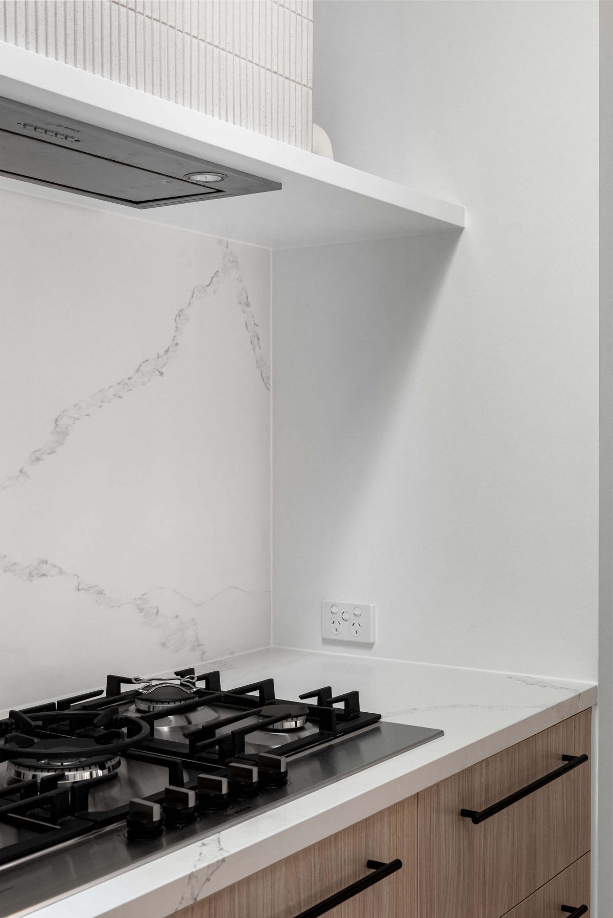 A custom designed kitchen featuring white Kit Kat files and brushed gunmetal tapware. Designed and built by MJ Harris Group. #MJHxBallantyneSt