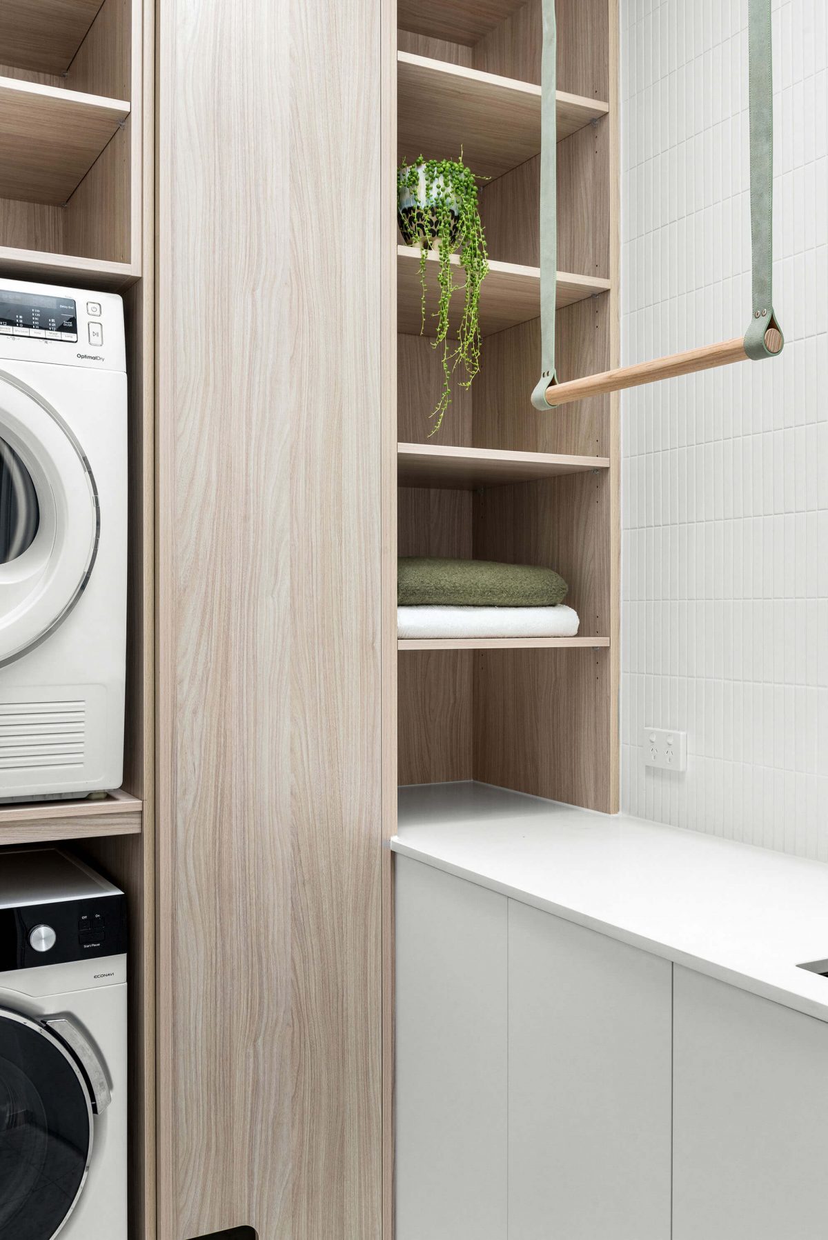 A custom designed laundry featuring a green and timber hanging rail. Designed and built by MJ Harris Group. #MJHxBallantyneSt