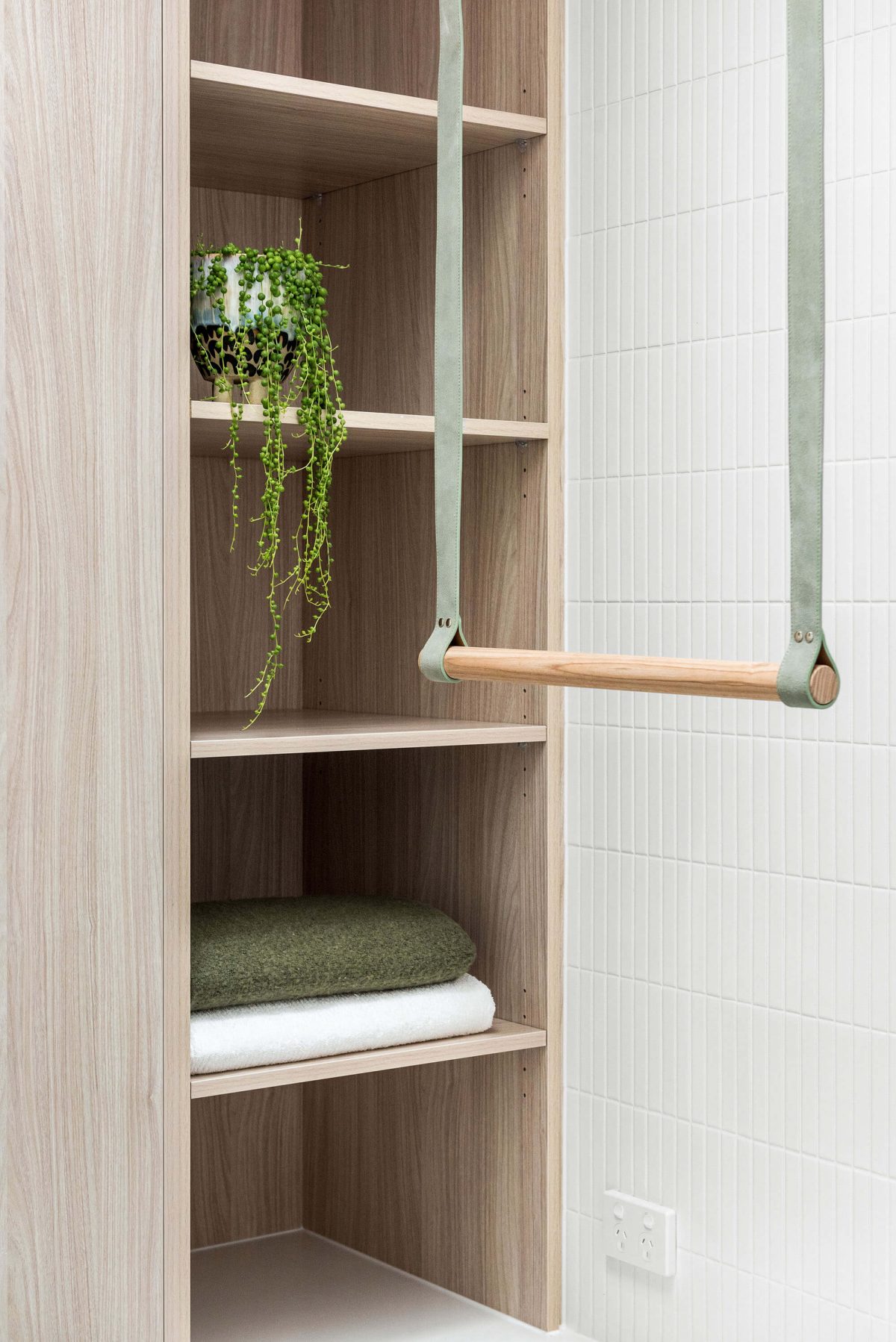 A custom designed laundry featuring a green and timber hanging rail. Designed and built by MJ Harris Group. #MJHxBallantyneSt