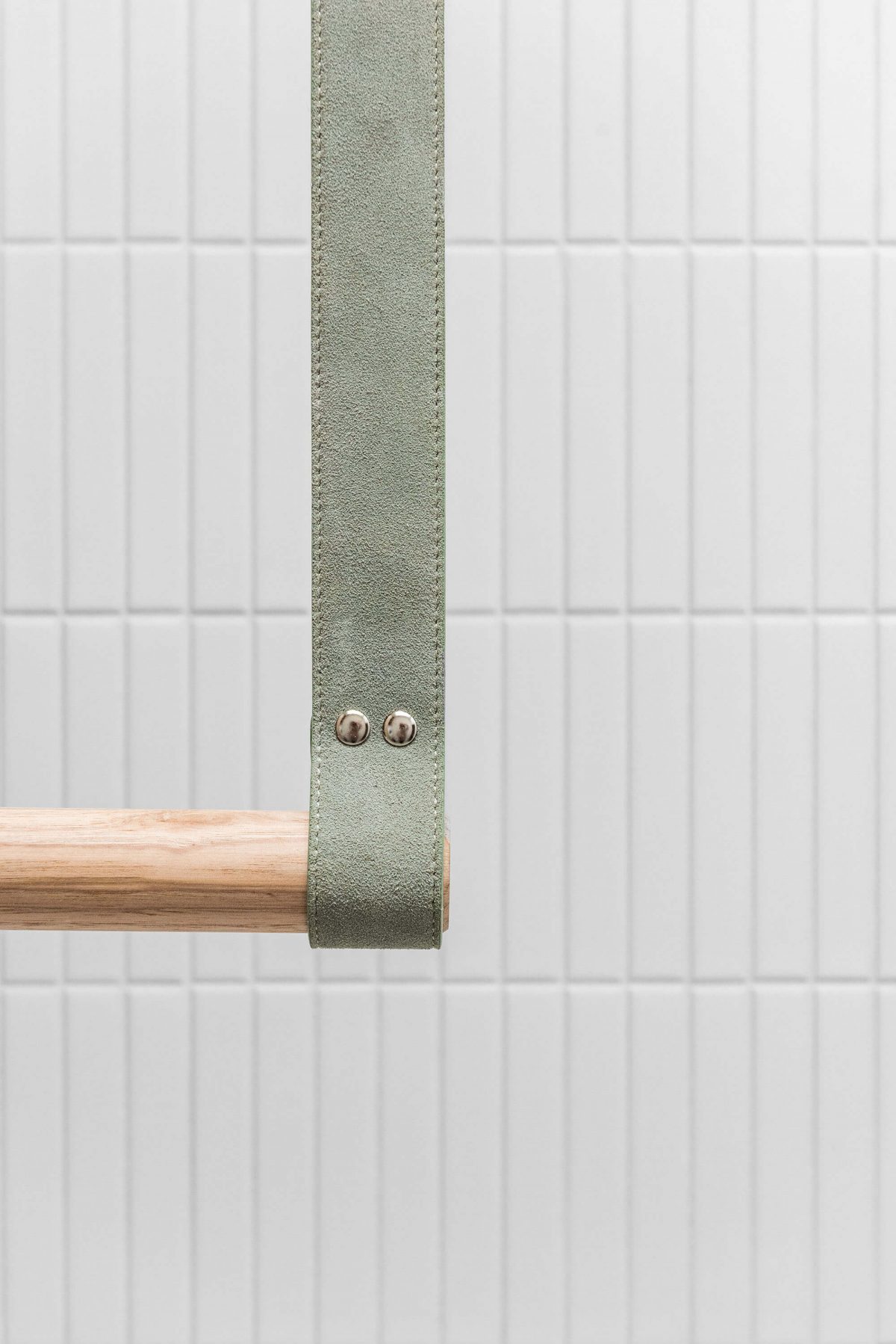 A custom designed laundry featuring a green and timber hanging rail. Designed and built by MJ Harris Group. #MJHxBallantyneSt