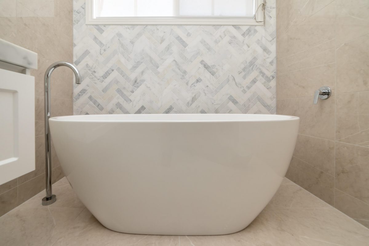 A custom designed bathroom featuring chrome fixtures. Designed and built by MJ Harris Group.