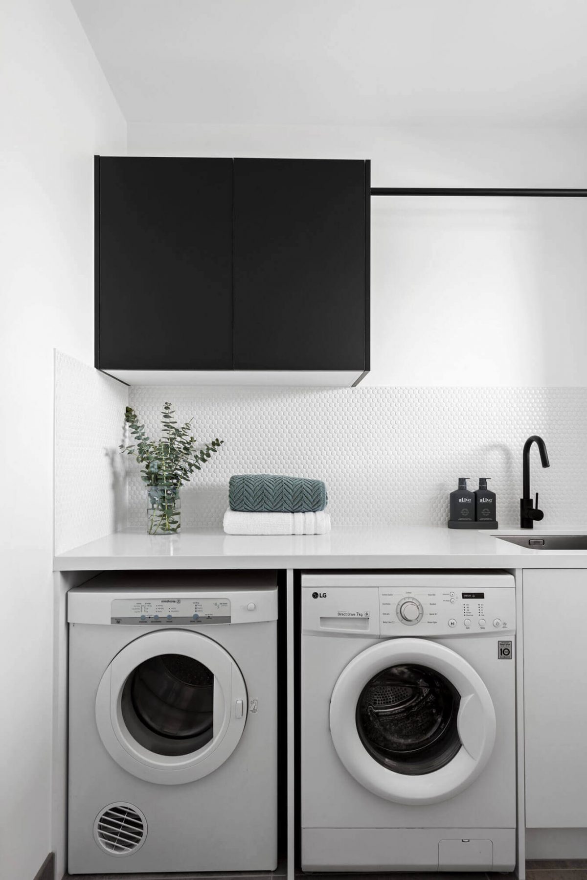 A custom designed laundry featuring a tiled splashback. Designed and built by MJ Harris Group. #MJHxWimmeraSt