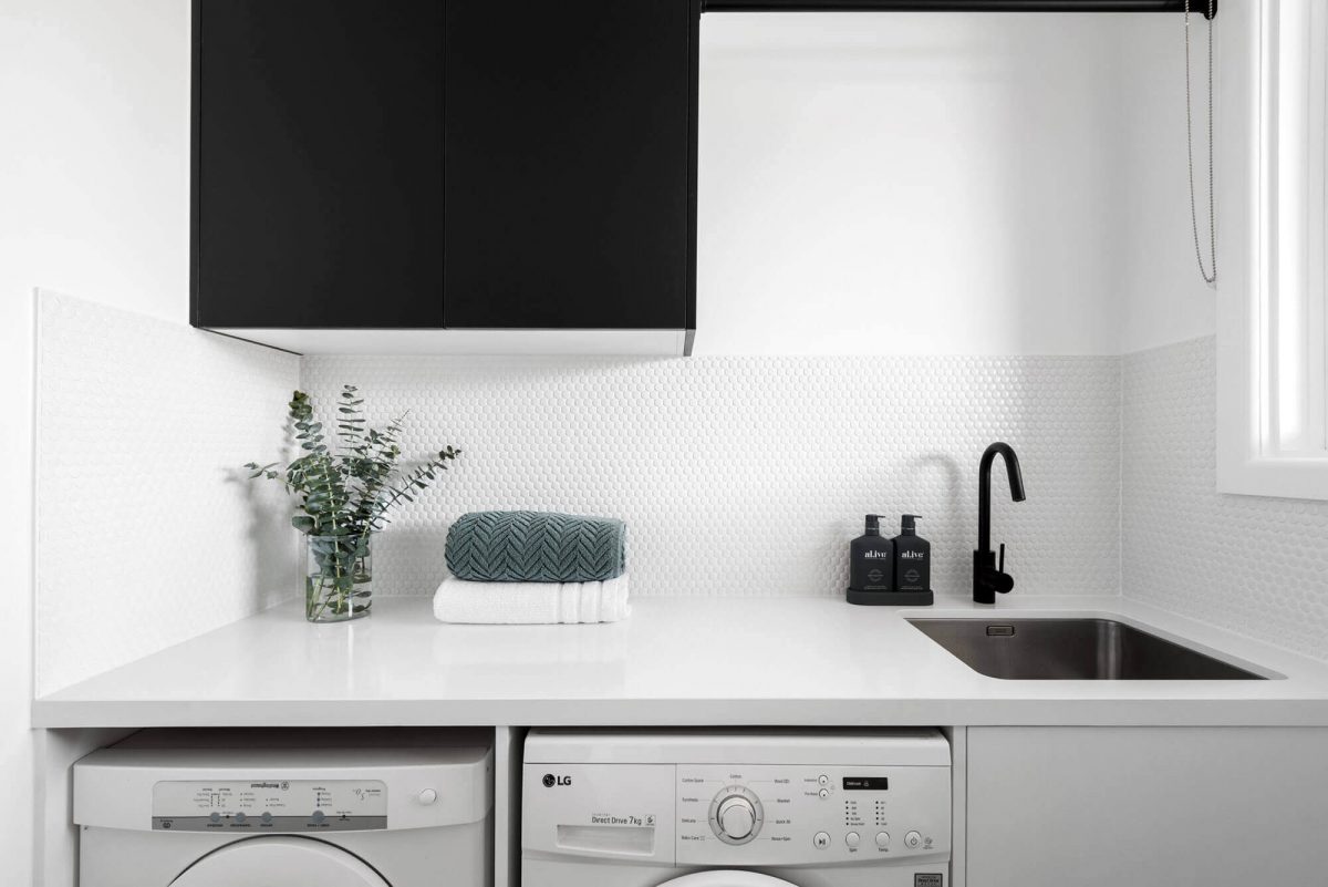 A custom designed laundry featuring a tiled splashback. Designed and built by MJ Harris Group. #MJHxWimmeraSt