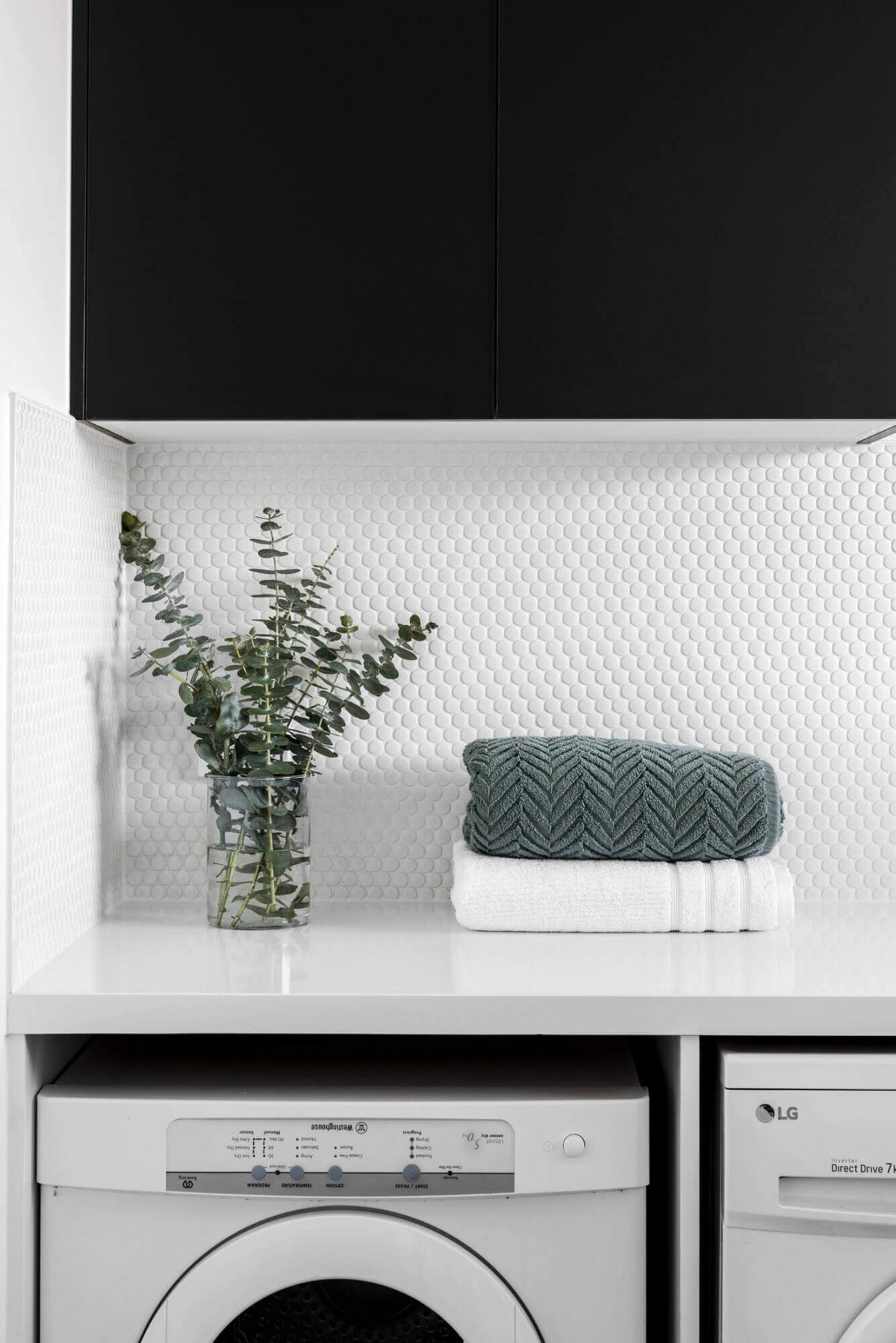 A custom designed laundry featuring a tiled splashback. Designed and built by MJ Harris Group. #MJHxWimmeraSt