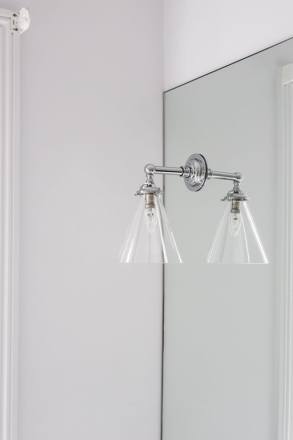 A custom designed bathroom featuring chrome fixtures. Designed and built by MJ Harris Group.