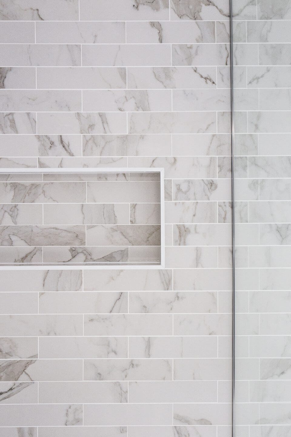 A custom designed bathroom featuring chrome fixtures. Designed and built by MJ Harris Group.