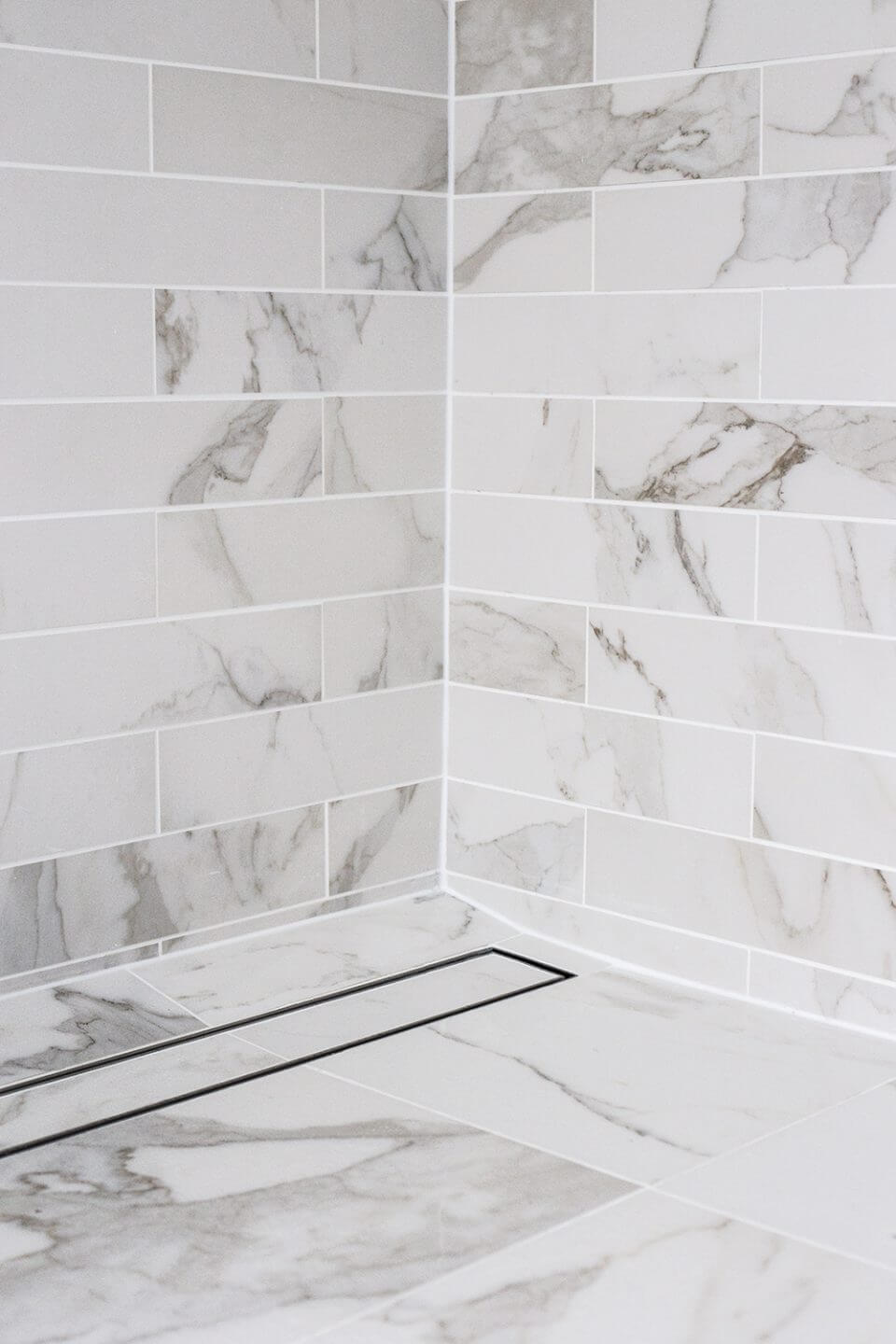 A custom designed bathroom featuring chrome fixtures. Designed and built by MJ Harris Group.
