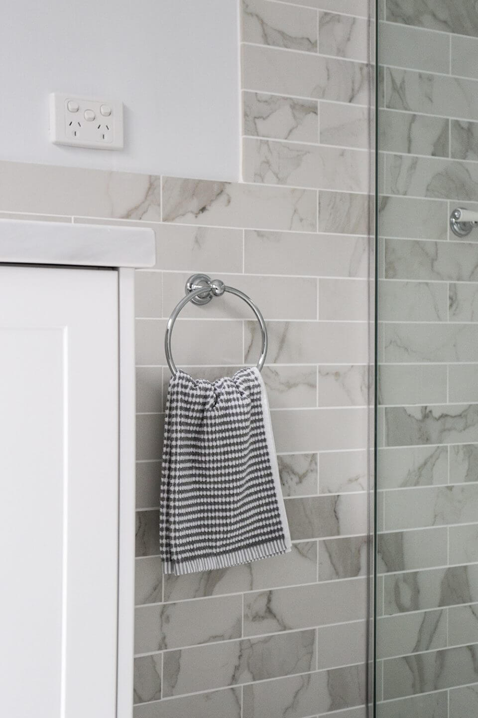 A custom designed bathroom featuring chrome fixtures. Designed and built by MJ Harris Group.