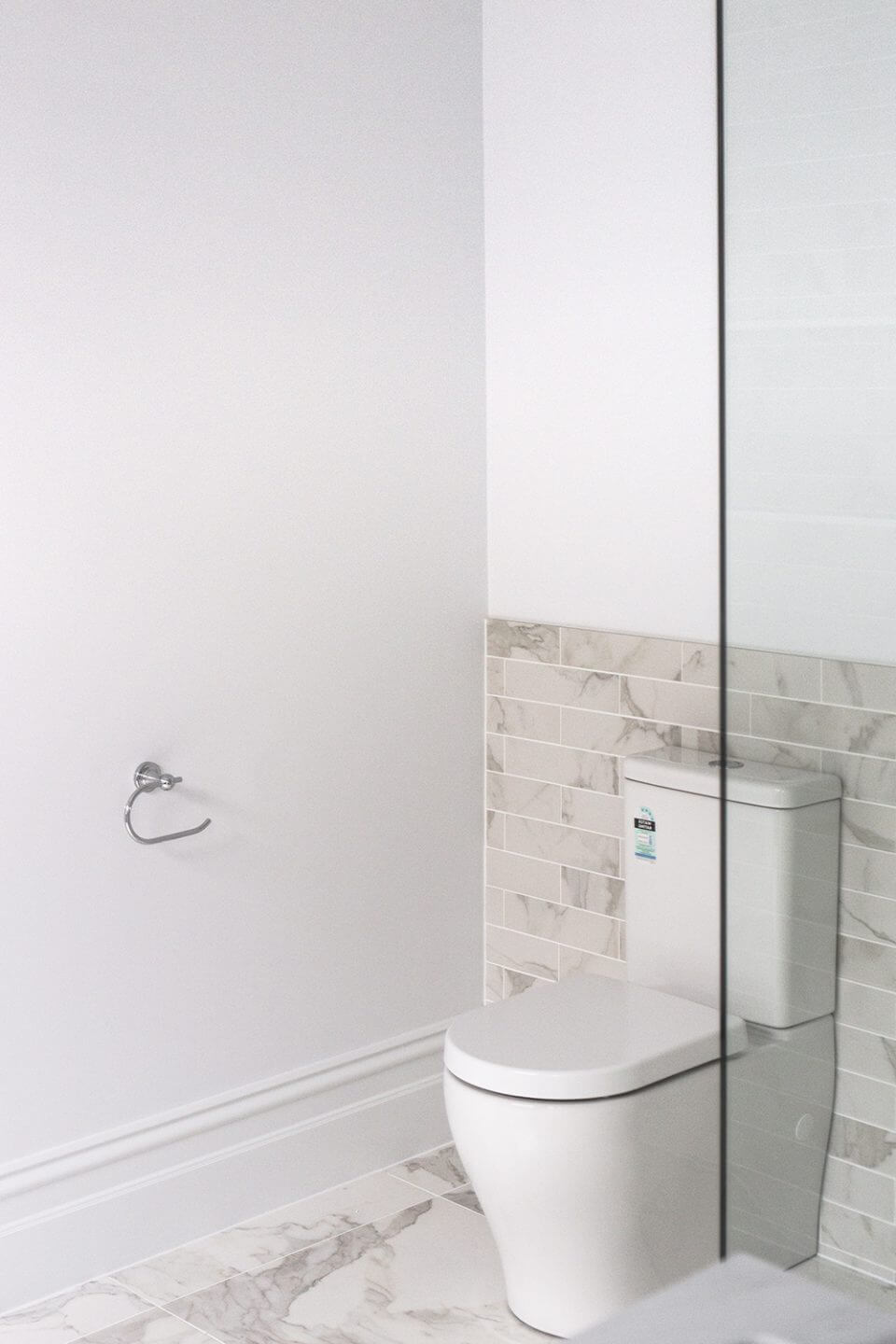 A custom designed bathroom featuring chrome fixtures. Designed and built by MJ Harris Group.