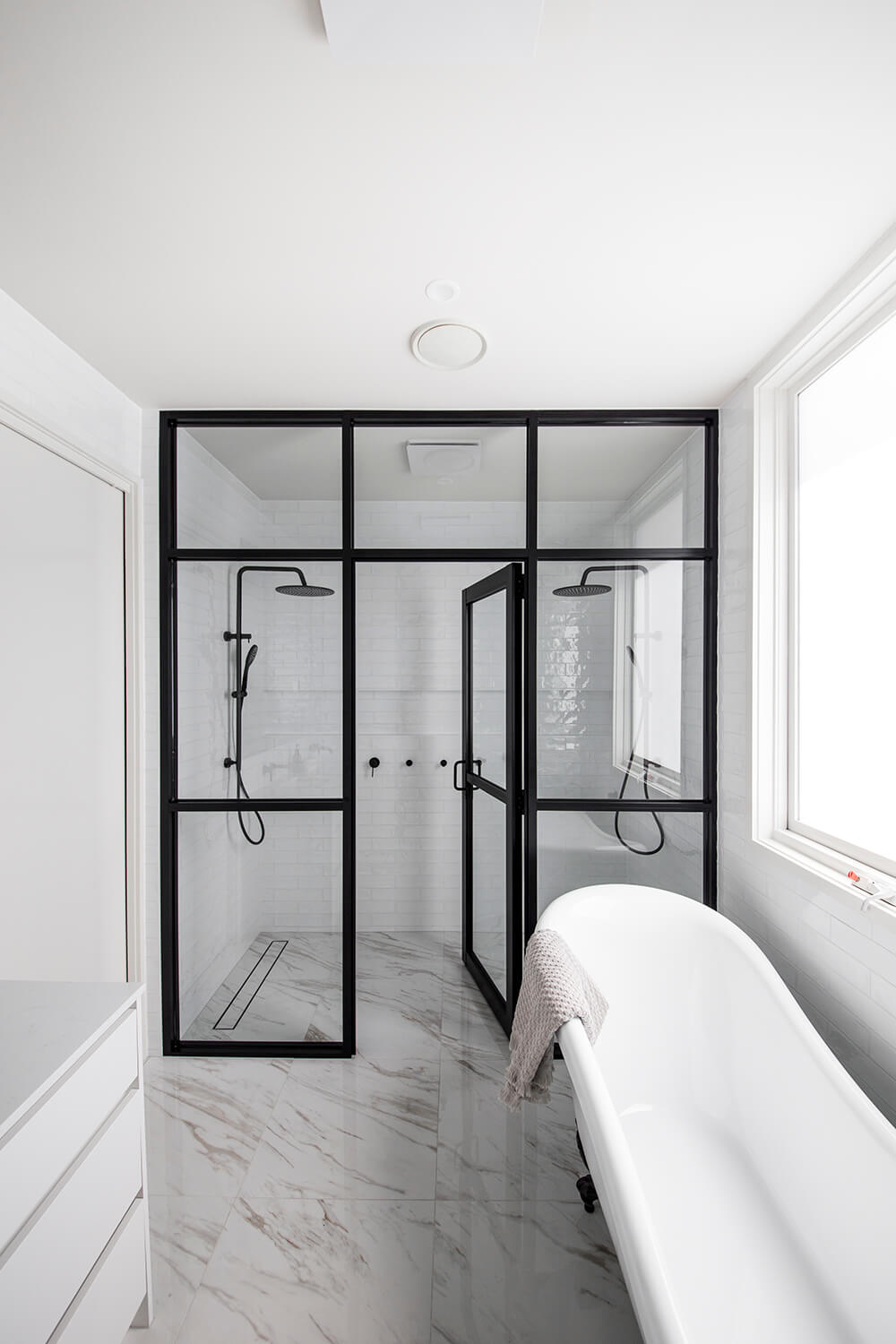 A custom designed bathroom featuring black accents. Designed and built by MJ Harris Group. #MJHxLuciferSt
