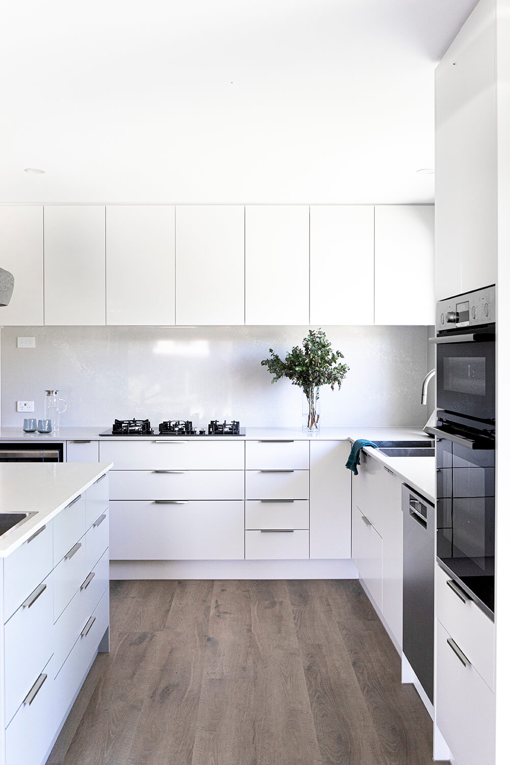 A custom designed kitchen featuring caesar stone bench. Designed and built by MJ Harris Group.