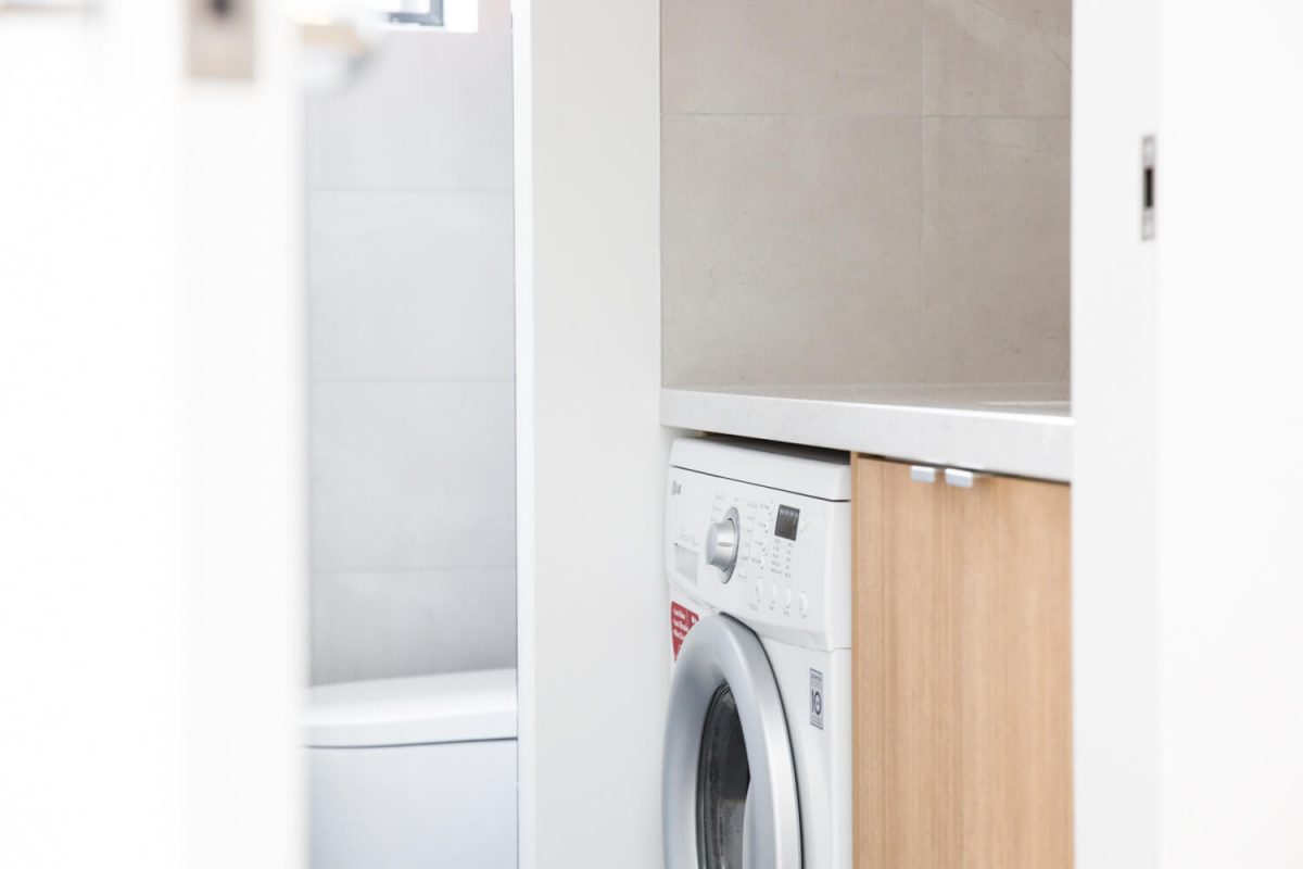 A custom designed laundry featuring custom joinery. Designed and built by MJ Harris Group.