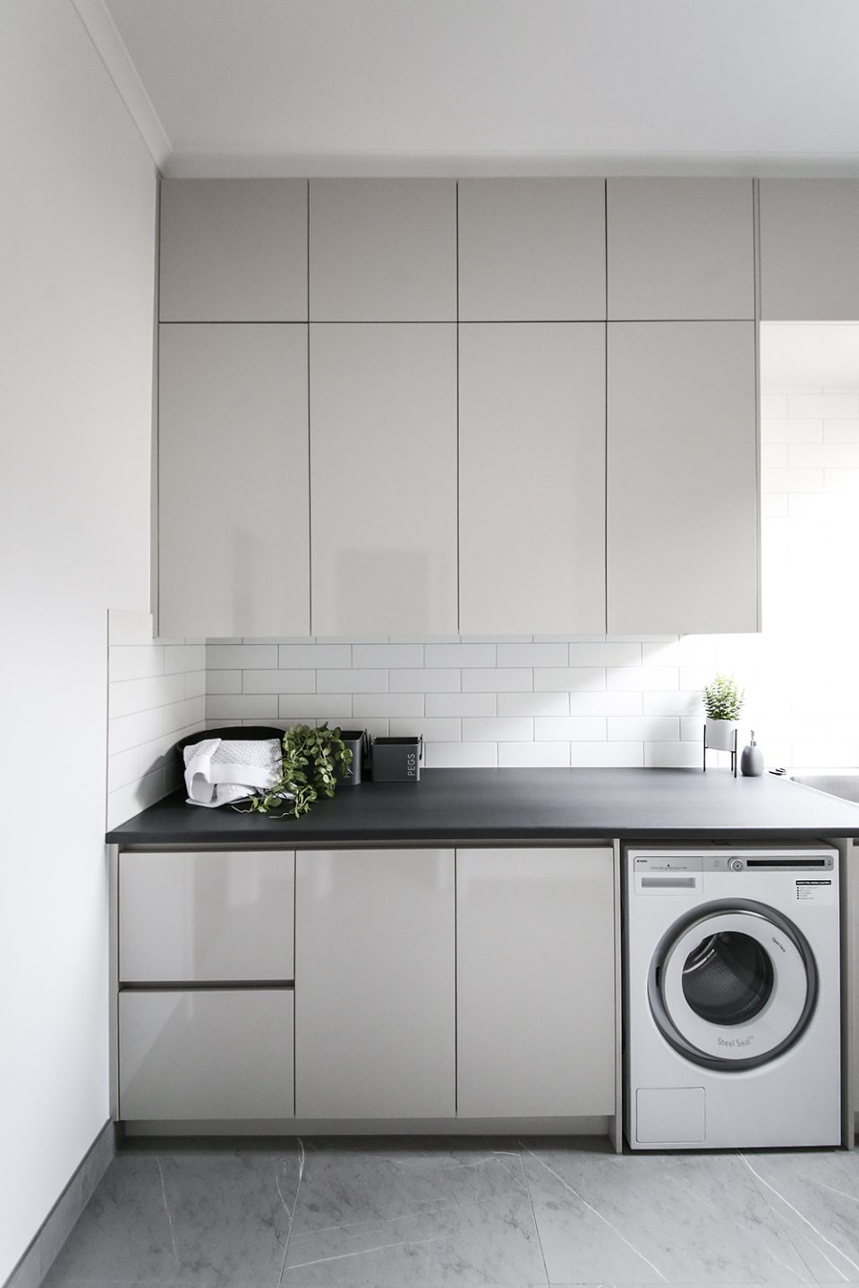 A custom designed laundry featuring custom joinery. Designed and built by MJ Harris Group.