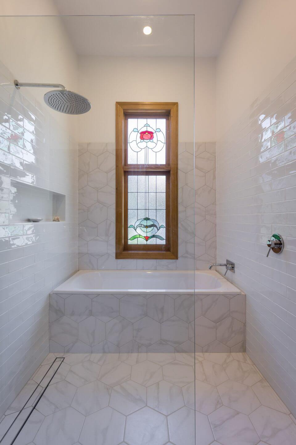 A custom designed bathroom featuring a walk in shower. Designed and built by MJ Harris Group.
