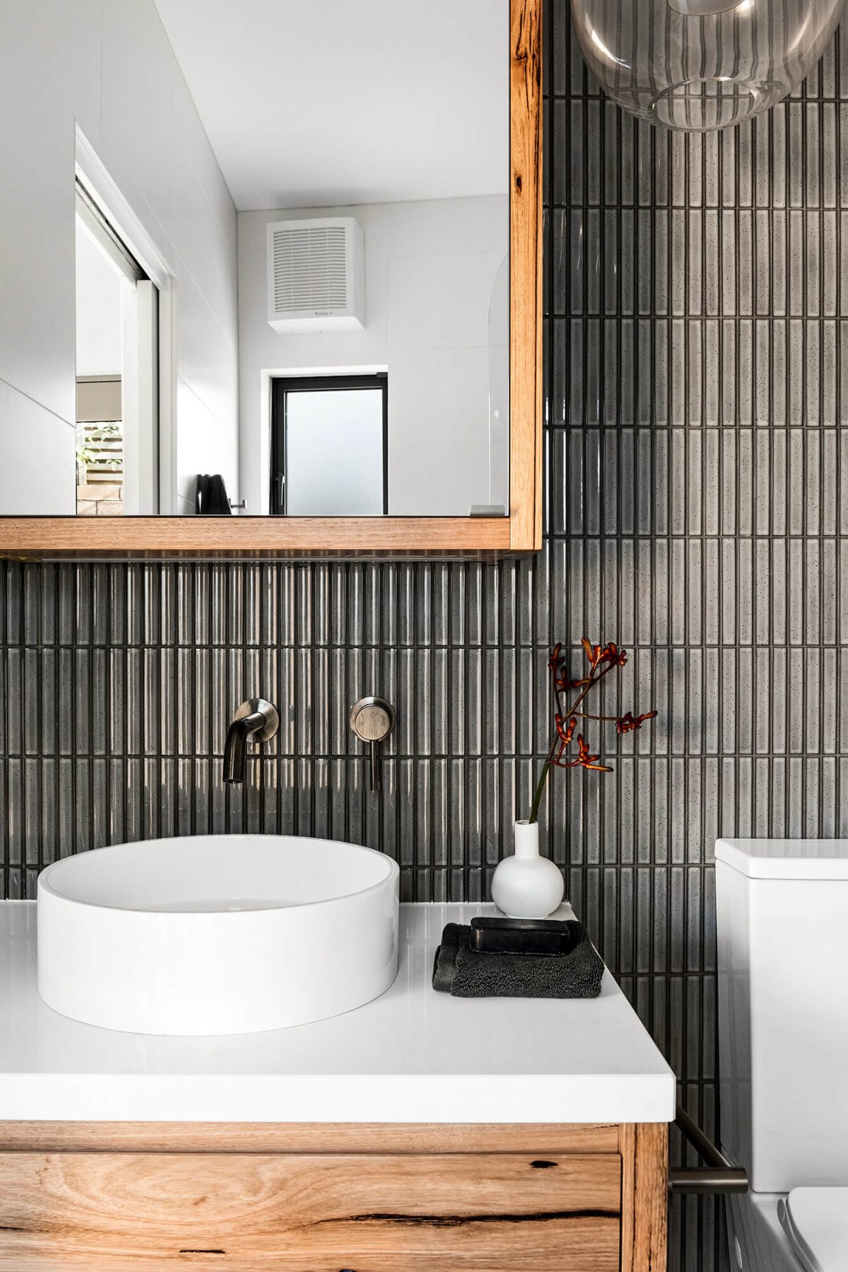 A custom designed bathroom featuring dark Kit Kat tiles. Designed and built by MJ Harris Group. #MJHxMasonSt