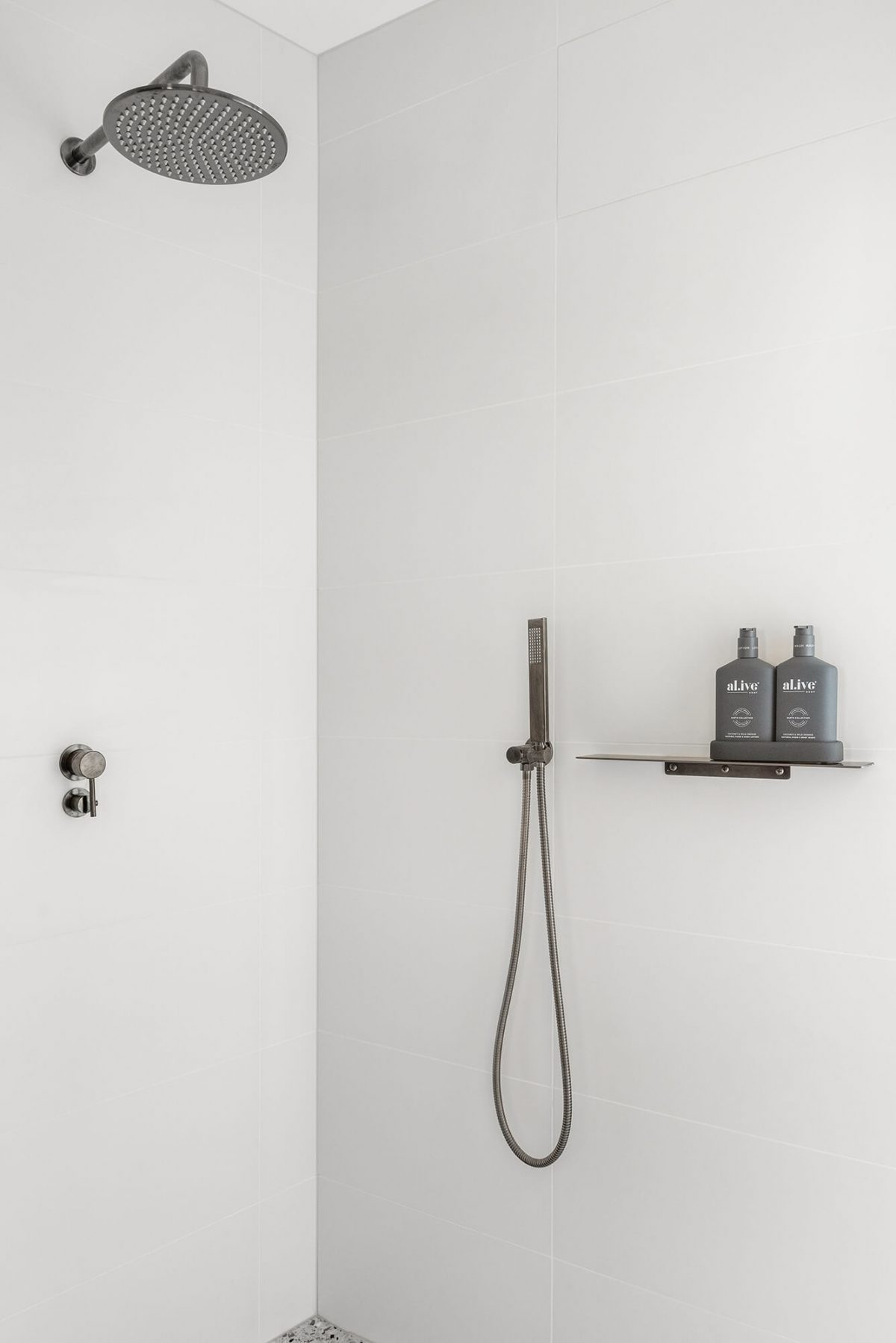 A custom designed bathroom featuring white tiles. Designed and built by MJ Harris Group. #MJHxMasonSt