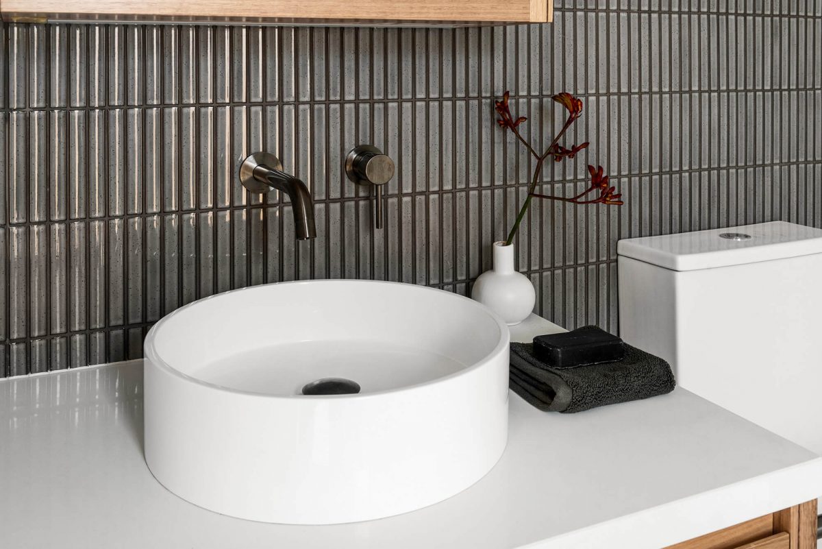 A custom designed bathroom featuring dark Kit Kat tiles. Designed and built by MJ Harris Group. #MJHxMasonSt