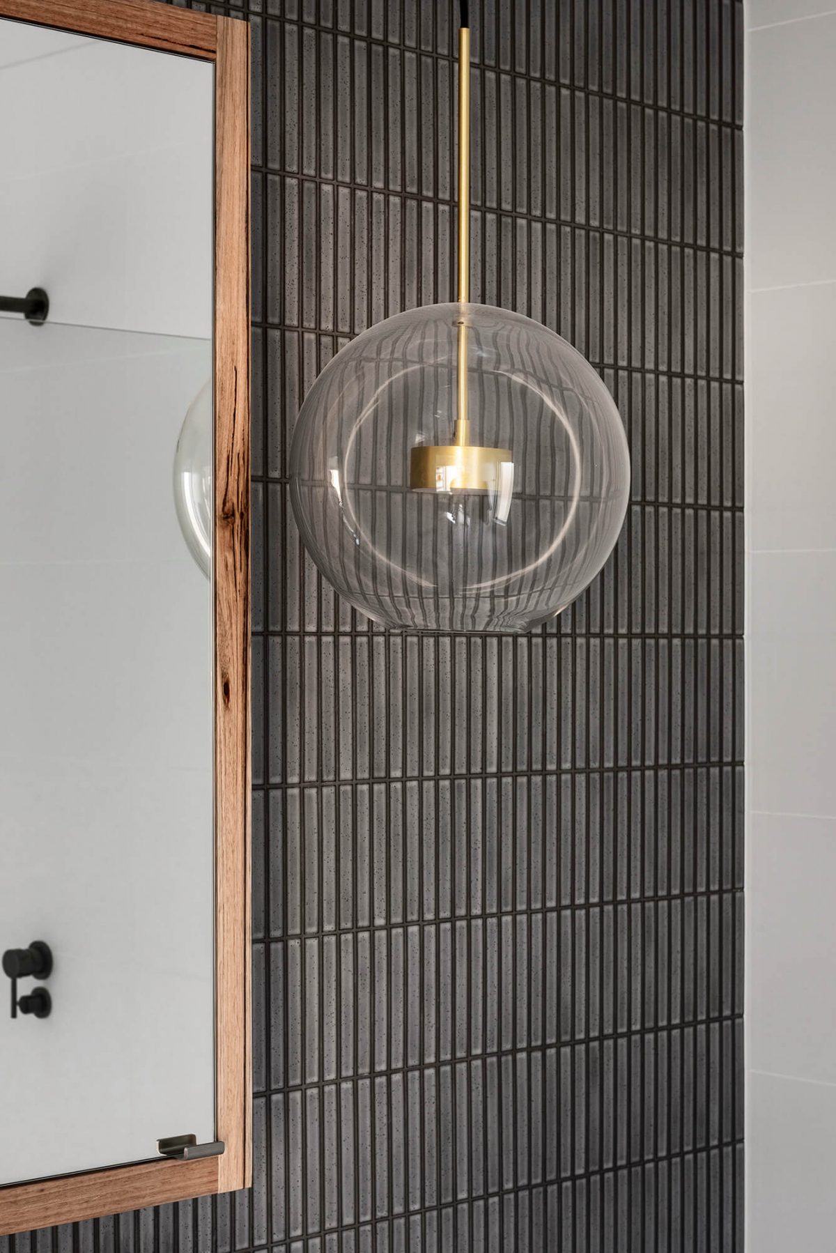 A custom designed bathroom featuring dark Kit Kat tiles. Designed and built by MJ Harris Group. #MJHxMasonSt