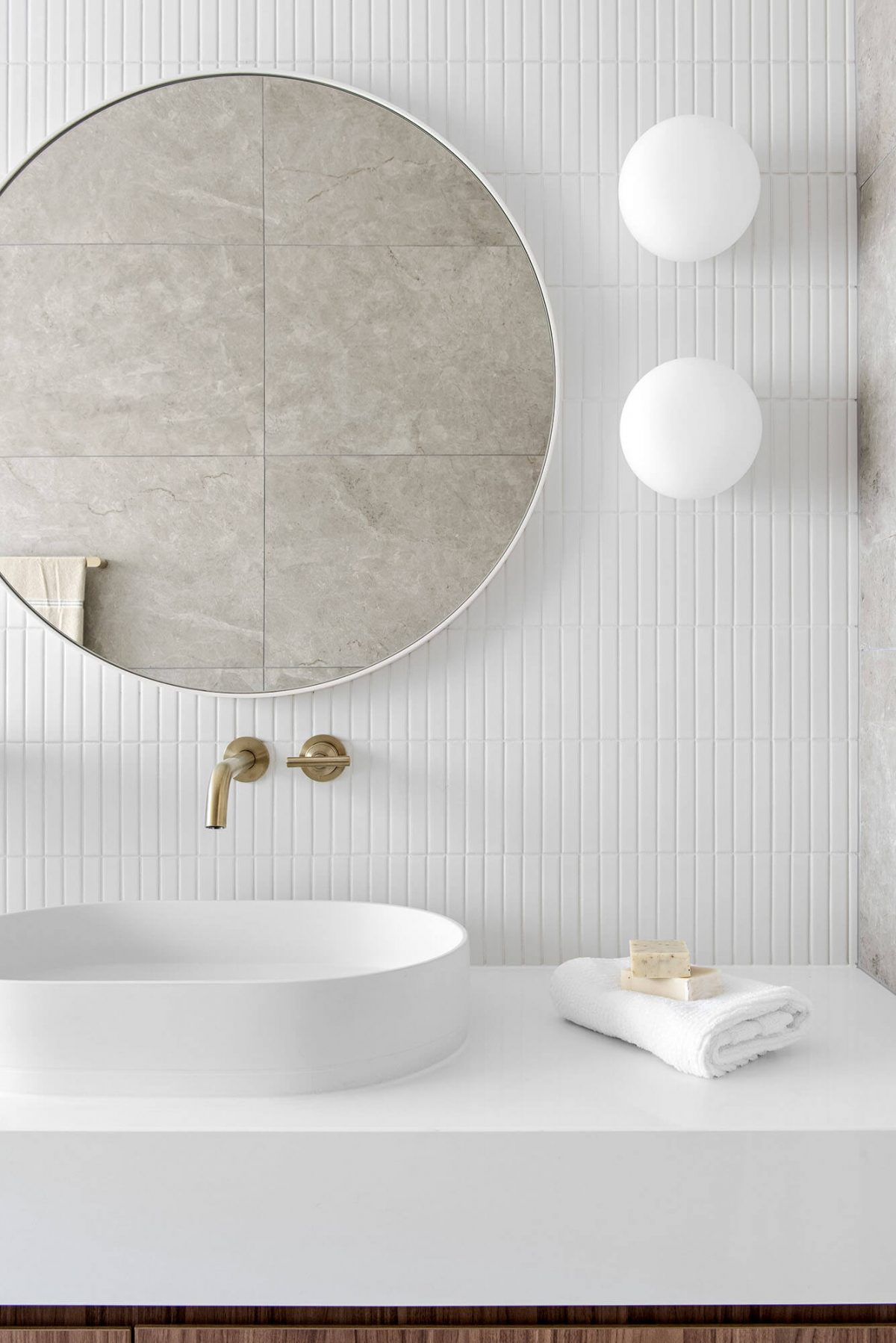 A custom designed bathroom featuring white Kit Kat tiles. Designed and built by MJ Harris Group.