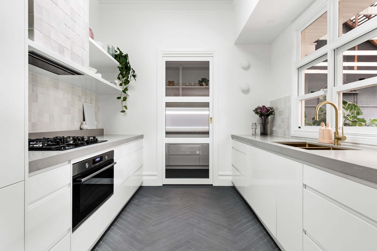 A custom designed galley kitchen featuring zeolite tiles. Designed and built by MJ Harris Group. #MJHxRoyalAve