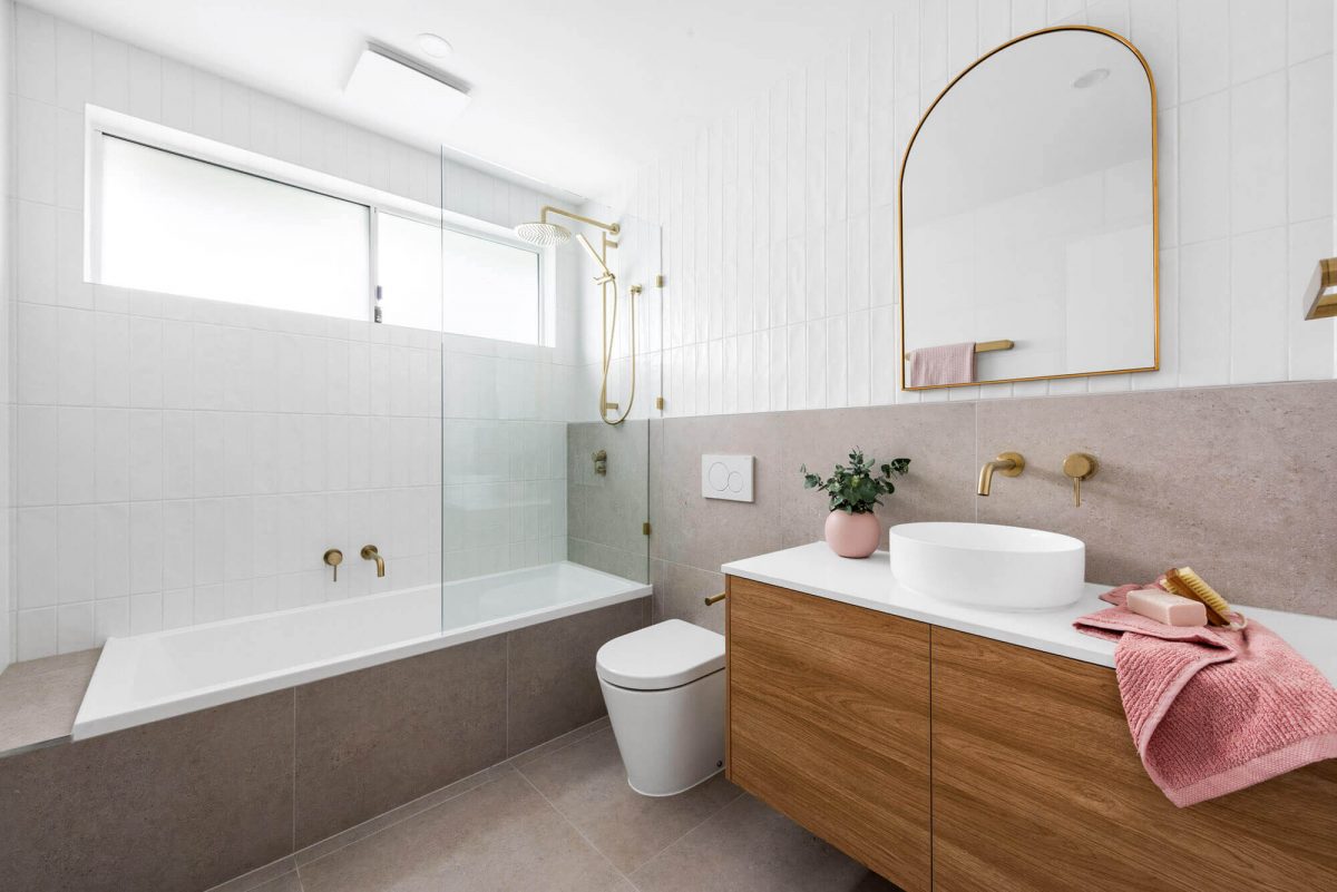 A custom designed bathroom featuring a white basin and gold accents. Designed and built by MJ Harris Group. #MJHxThompsonSt