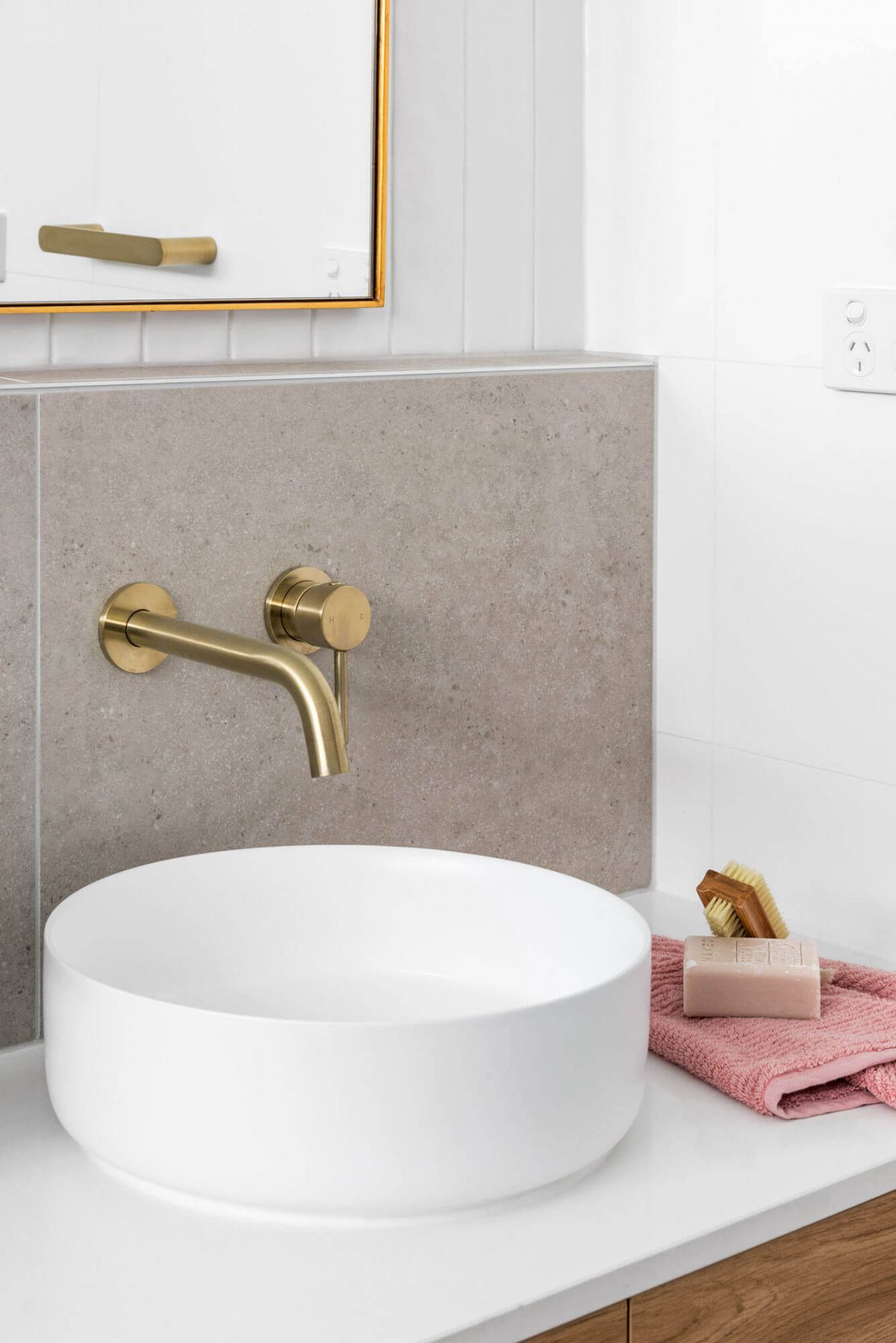 A custom designed bathroom featuring a white basin and gold accents. Designed and built by MJ Harris Group. #MJHxThompsonSt