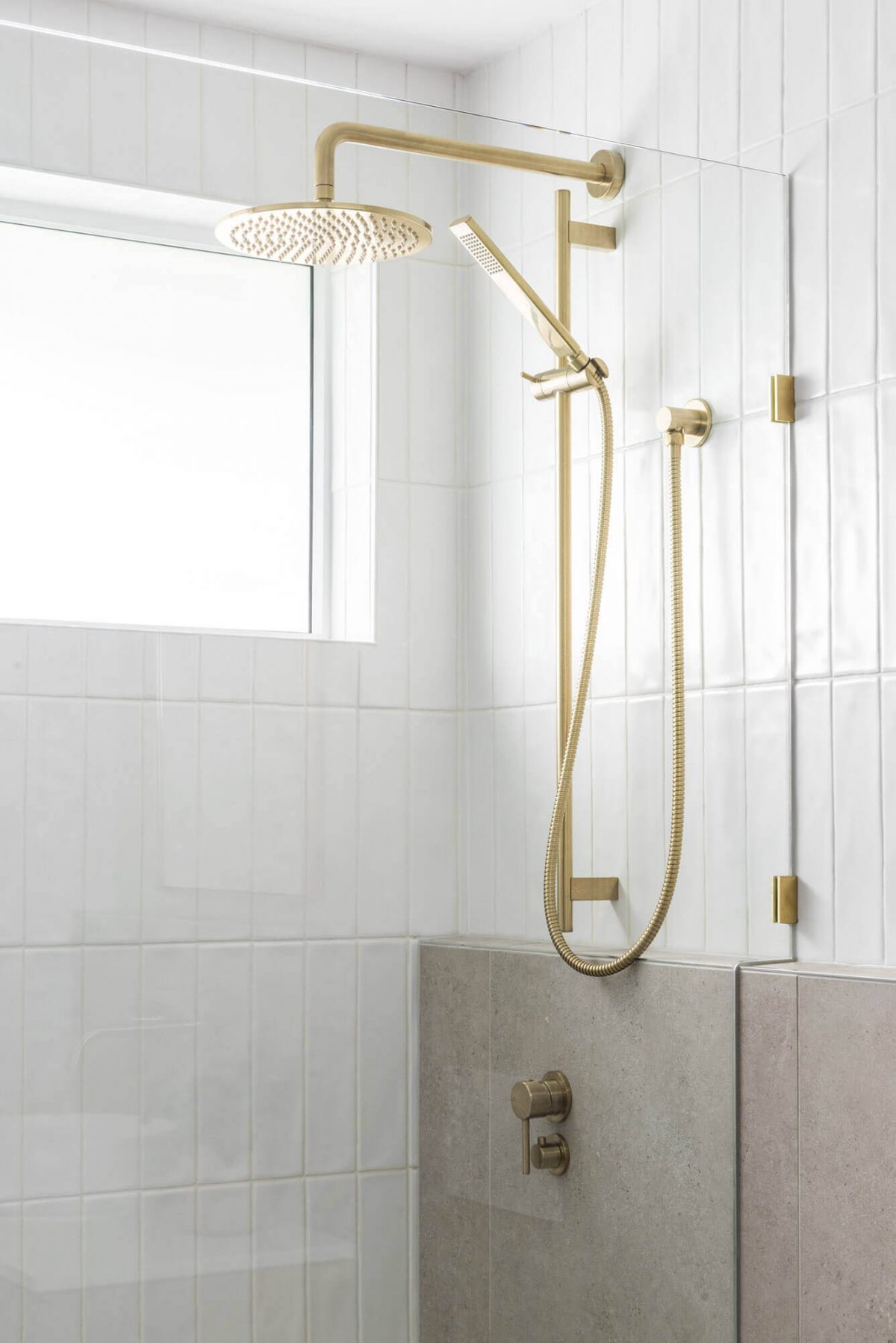 A custom designed bathroom featuring a double shower and gold accents. Designed and built by MJ Harris Group. #MJHxThompsonSt