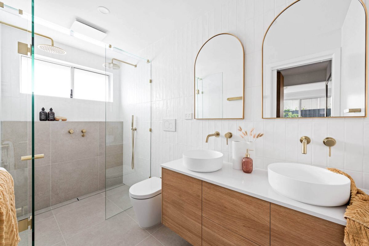 A custom designed bathroom featuring a double shower and gold accents. Designed and built by MJ Harris Group. #MJHxThompsonSt