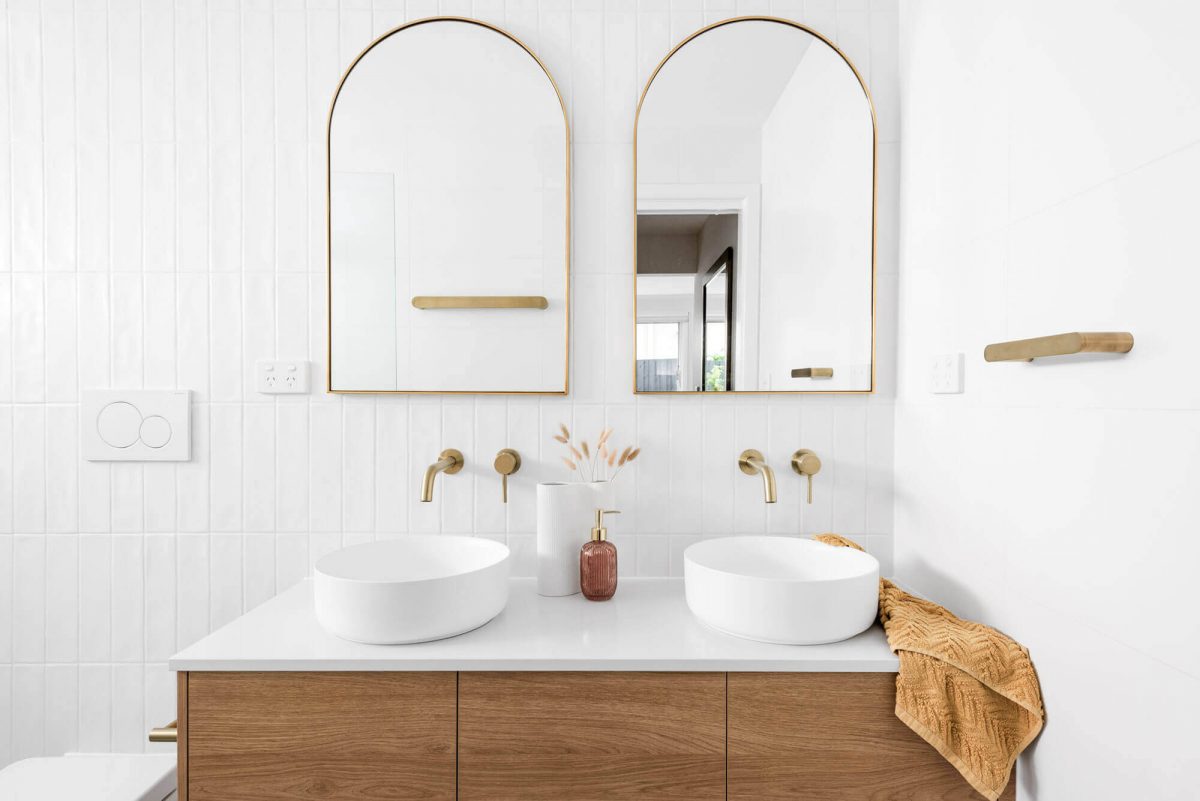 A custom designed bathroom featuring a double shower and gold accents. Designed and built by MJ Harris Group. #MJHxThompsonSt