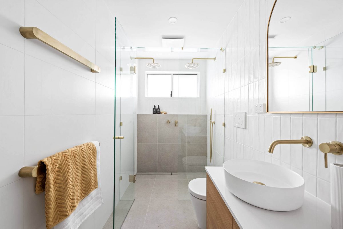 A custom designed bathroom featuring a double shower and gold accents. Designed and built by MJ Harris Group. #MJHxThompsonSt