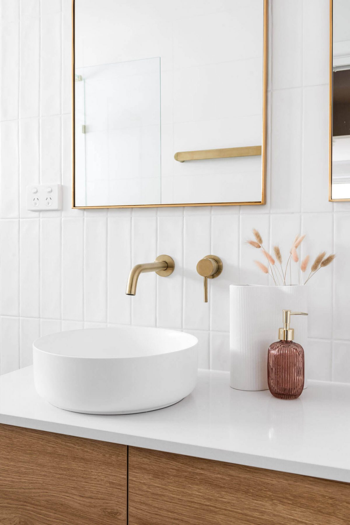 A custom designed bathroom featuring a white basin and gold accents. Designed and built by MJ Harris Group. #MJHxThompsonSt