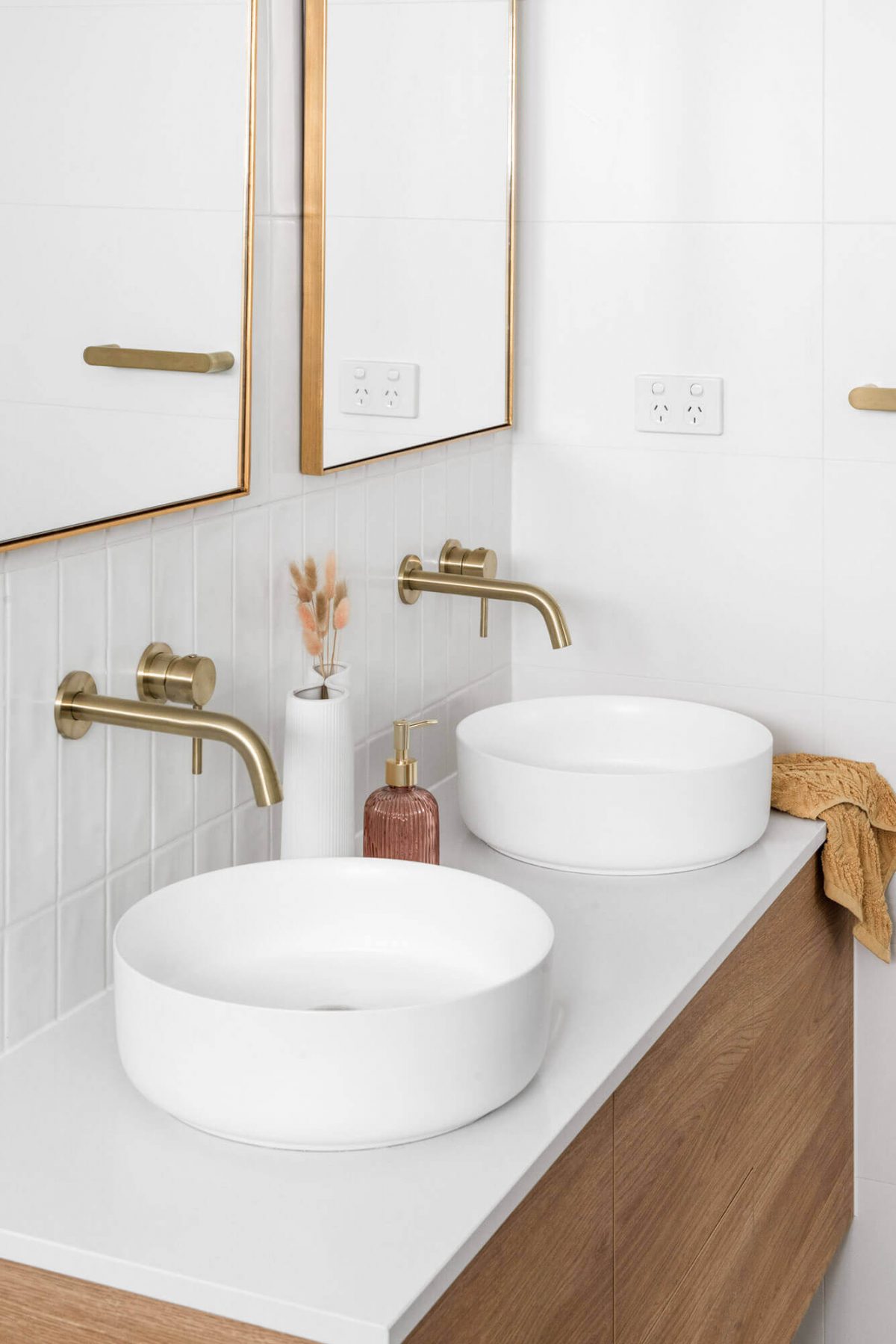 A custom designed bathroom featuring a white basin and gold accents. Designed and built by MJ Harris Group. #MJHxThompsonSt