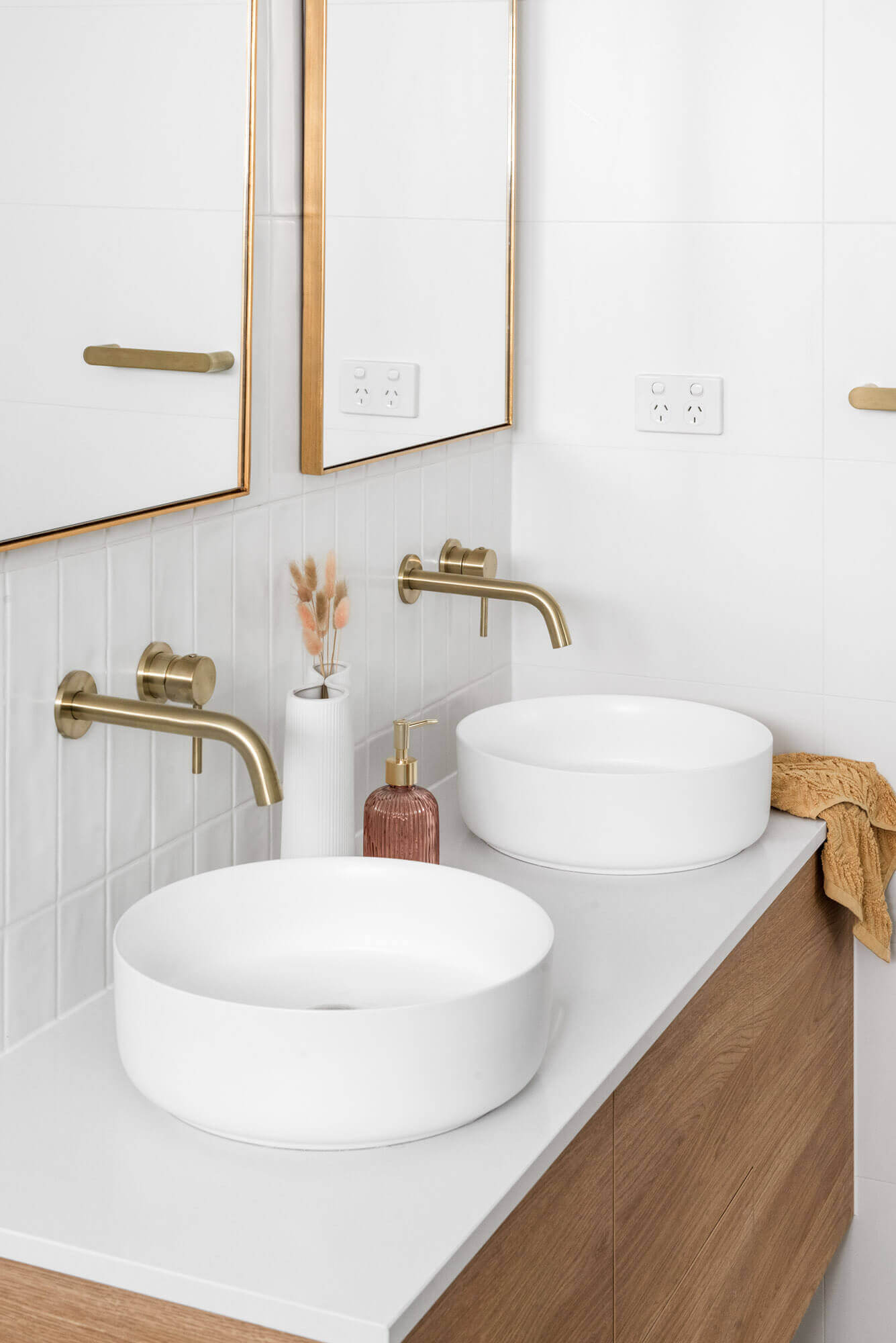 A custom designed bathroom featuring a white basin and gold accents. Designed and built by MJ Harris Group. #MJHxThompsonSt