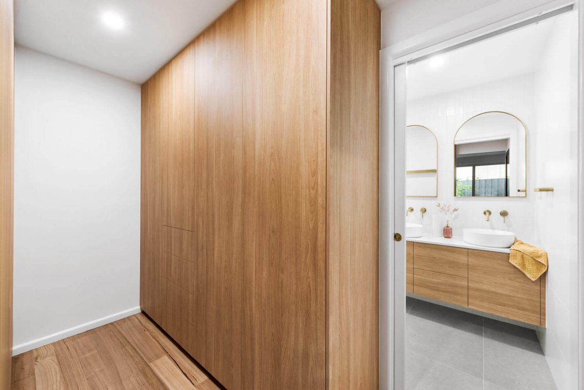 A custom designed walk in robe featuring floor to ceiling custom joinery. Designed and built by MJ Harris Group. #MJHxThompsonSt