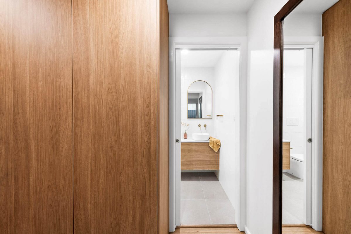 A custom designed walk in robe featuring floor to ceiling custom joinery. Designed and built by MJ Harris Group. #MJHxThompsonSt