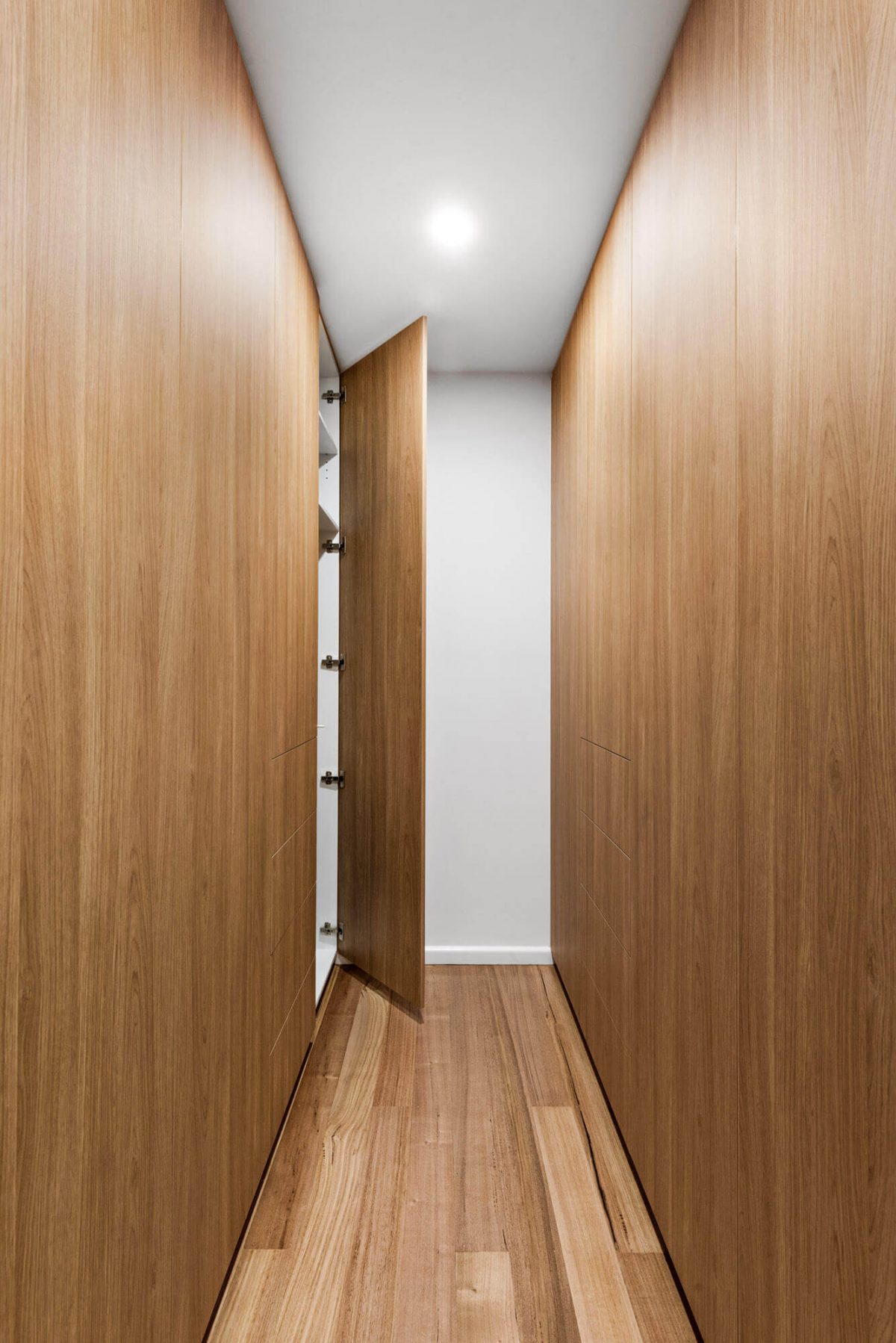 A custom designed walk in robe featuring floor to ceiling custom joinery. Designed and built by MJ Harris Group. #MJHxThompsonSt