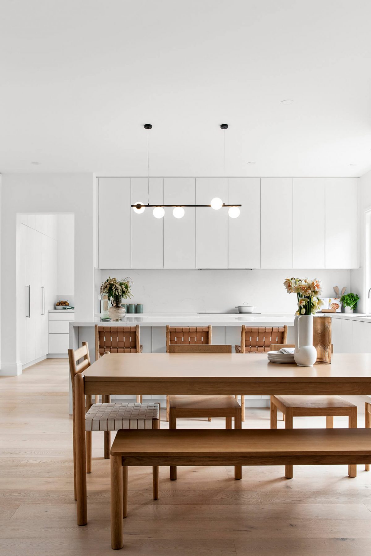 A custom designed kitchen featuring white custom joinery. Designed and built by MJ Harris Group. #MJHxFitzgibbonCres