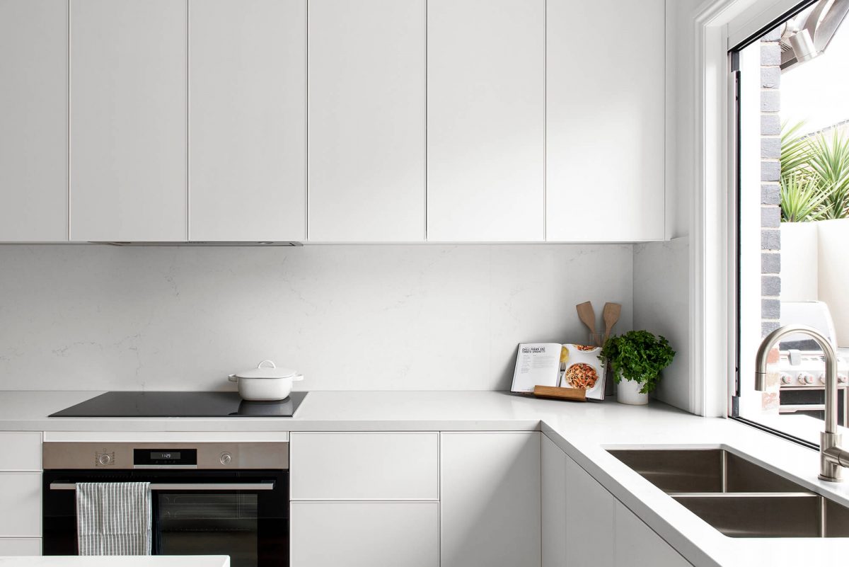A custom designed kitchen featuring white custom joinery. Designed and built by MJ Harris Group. #MJHxFitzgibbonCres