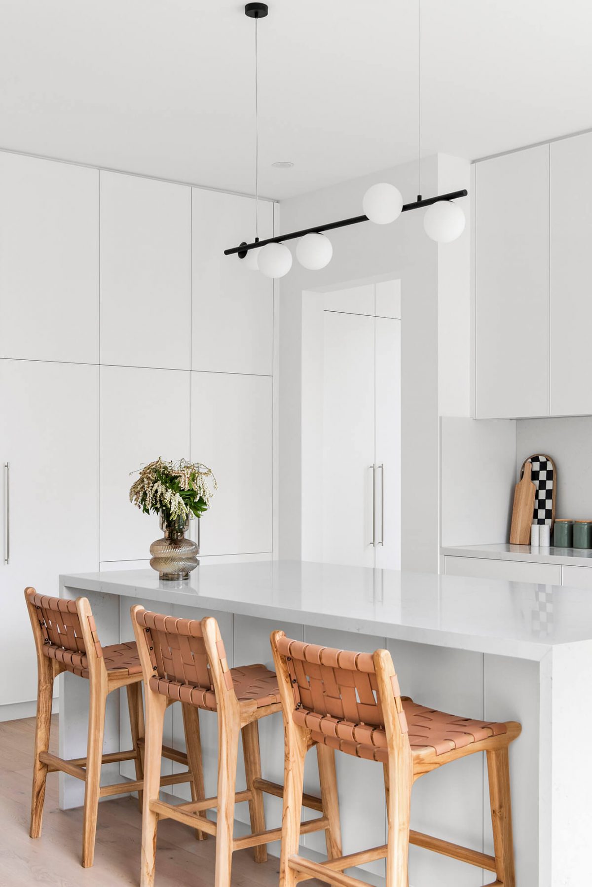 A custom designed kitchen featuring white custom joinery. Designed and built by MJ Harris Group. #MJHxFitzgibbonCres